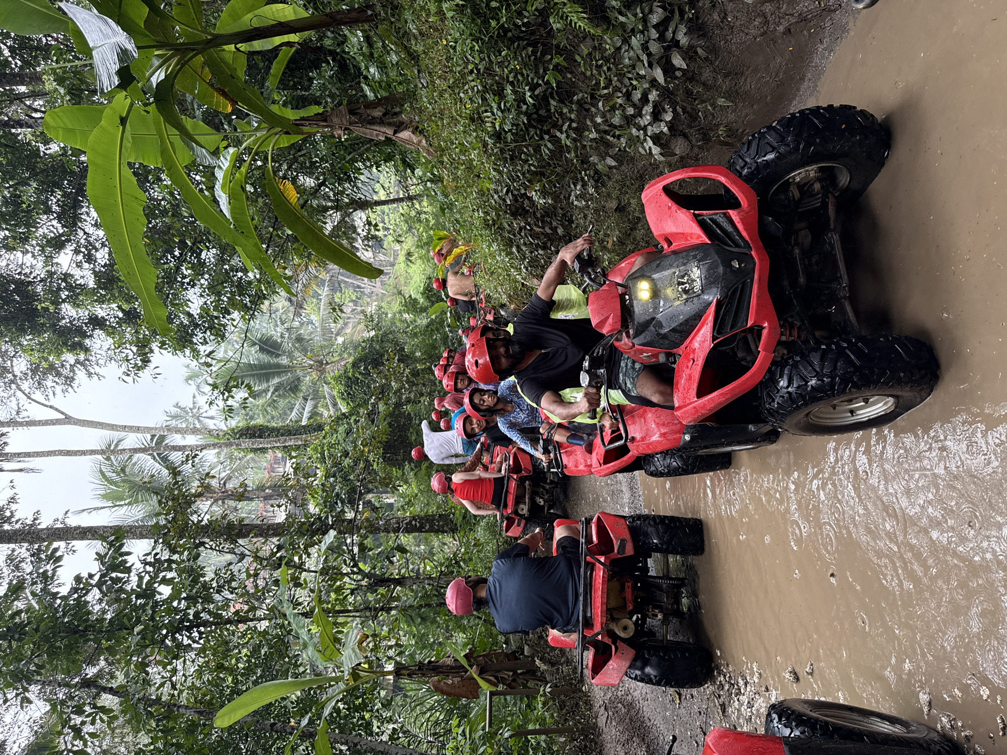 ATV group rides muddy trails through tropical Payangan jungle