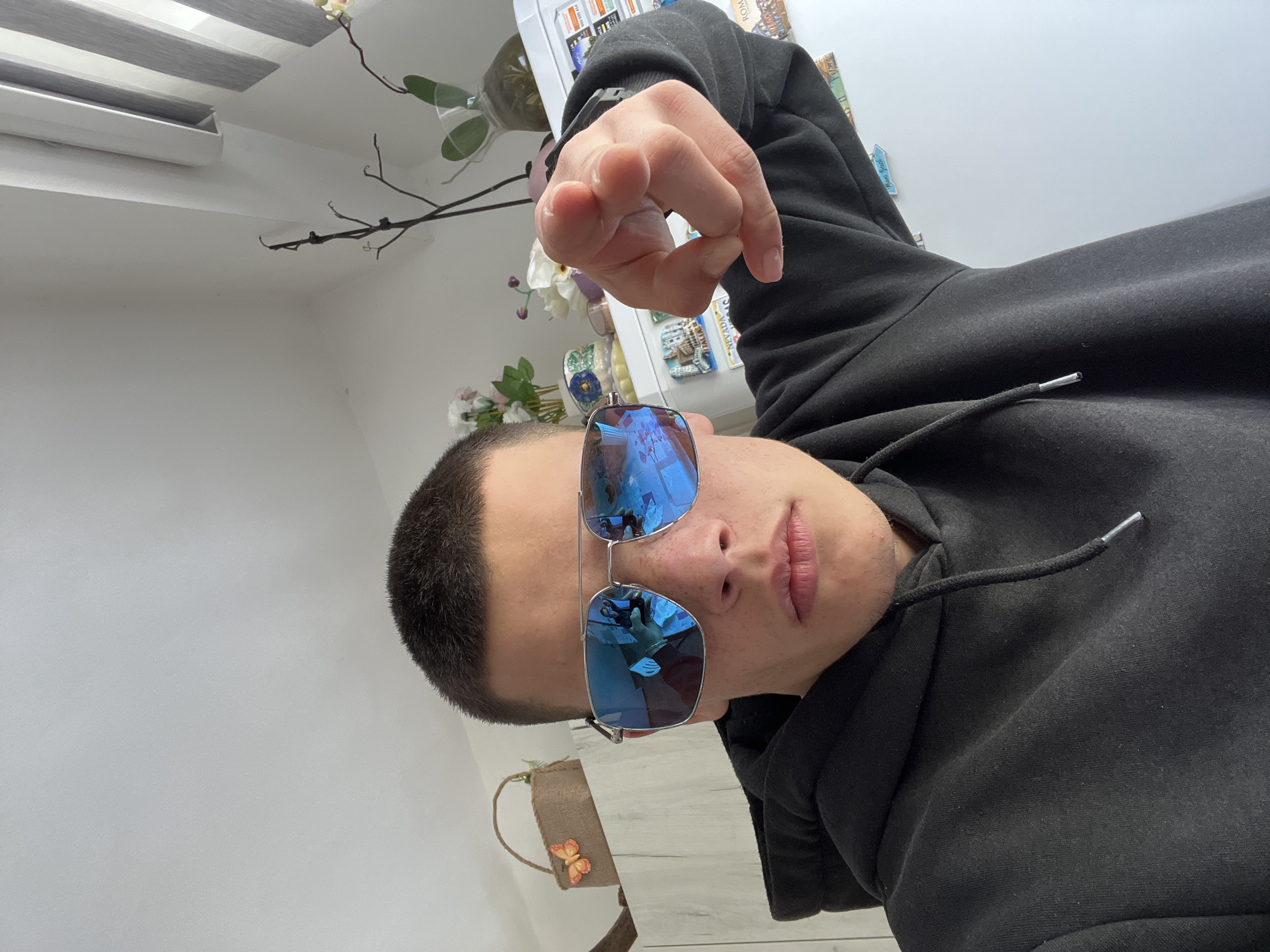 Person in sunglasses poses playfully indoors in Sopot, Bulgaria