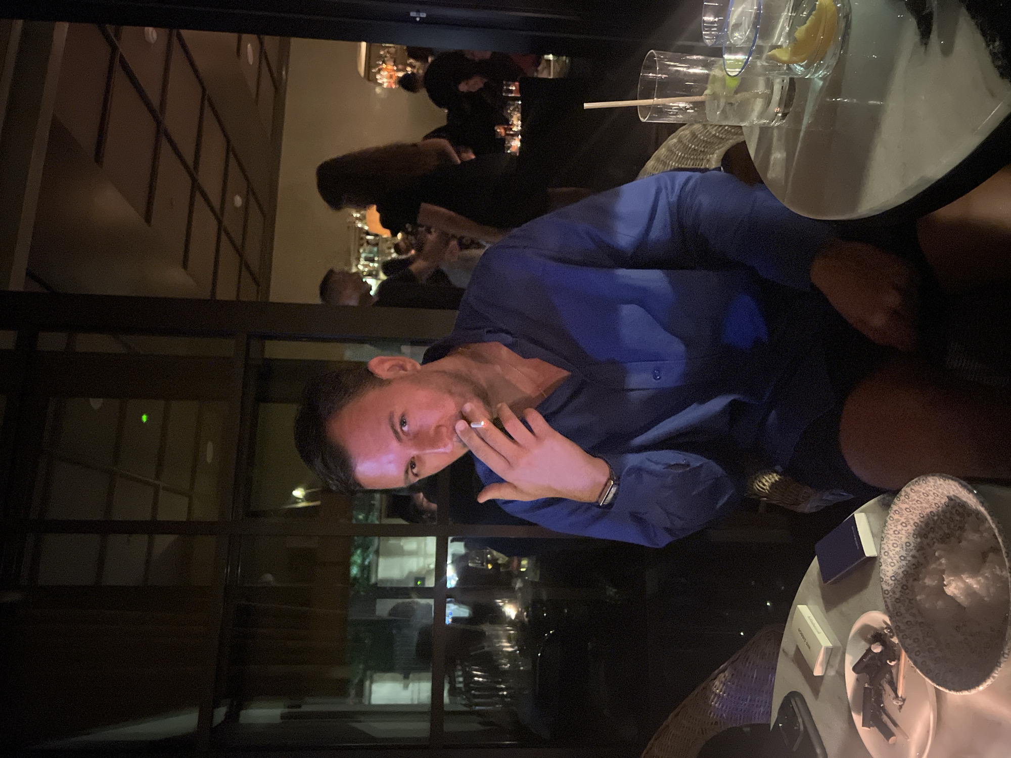 Late-night cigarettes and dinner at a dim London restaurant