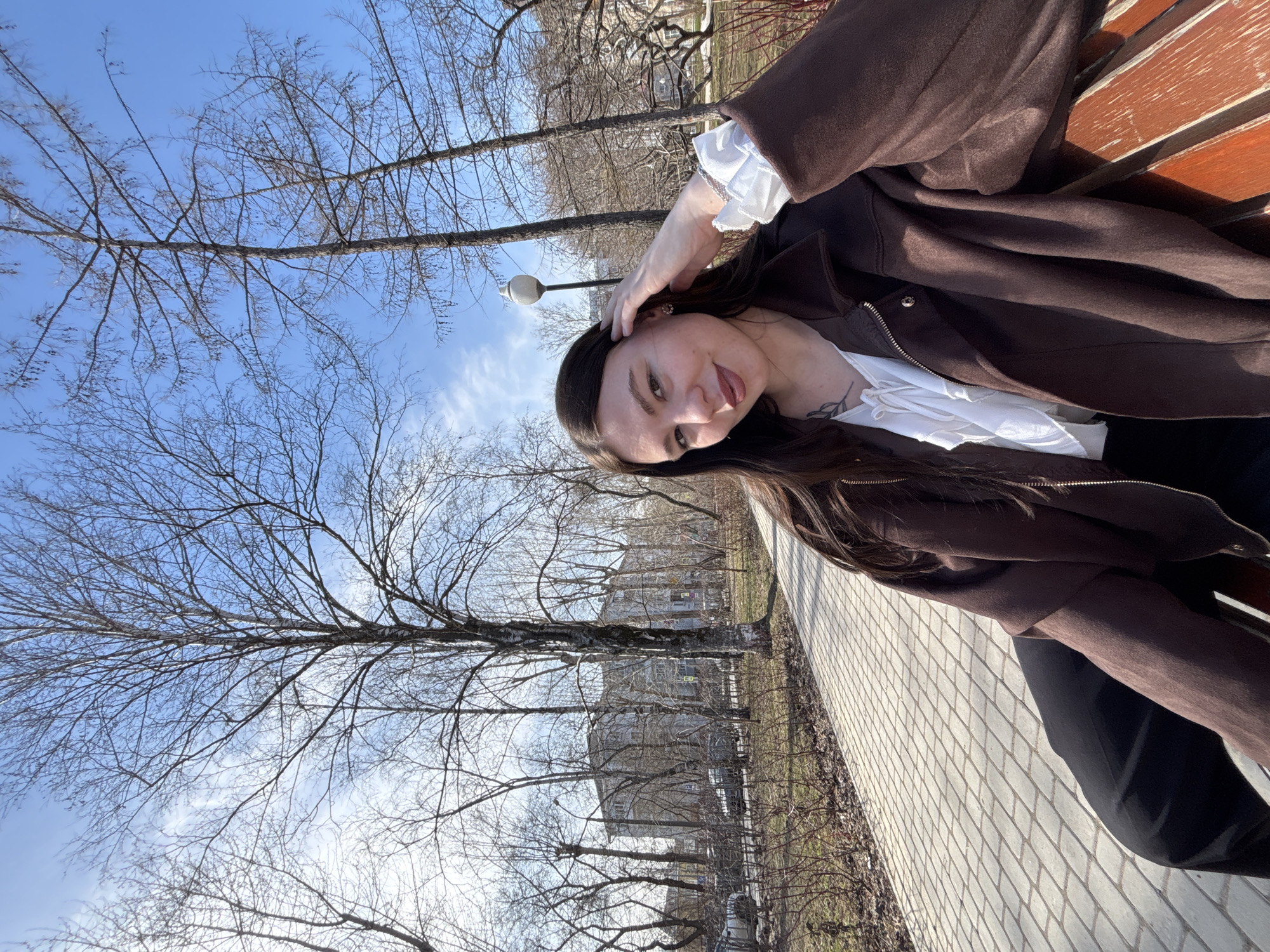 Woman sits on park bench in Perm, Russia