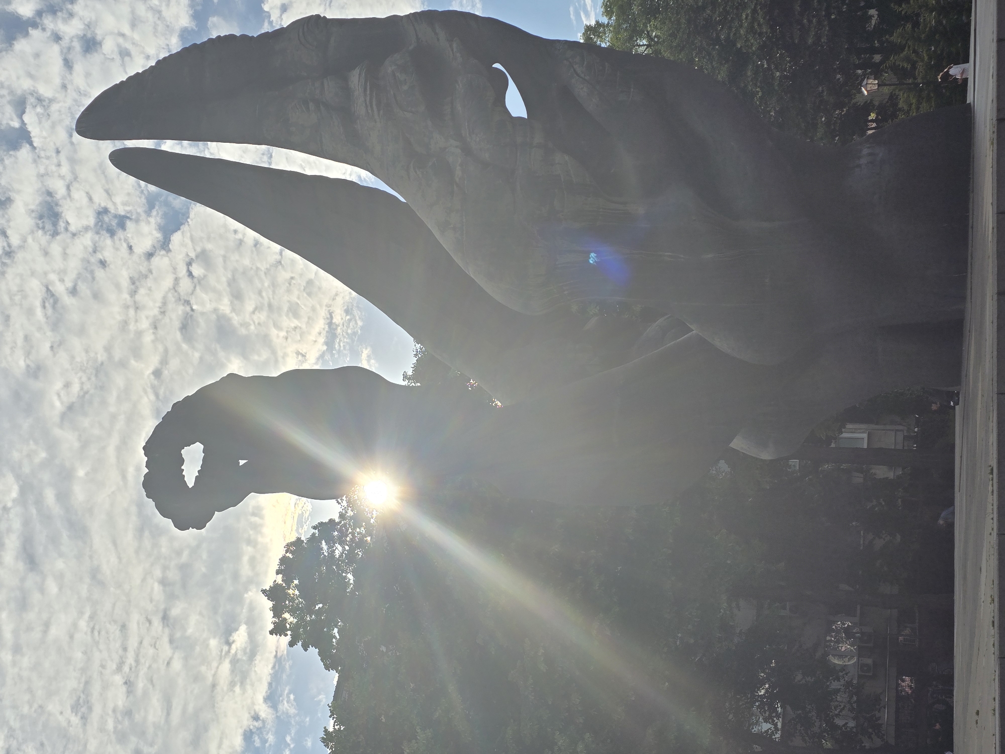 Urban afternoon scenes: traffic, sculptures, parked cars documented