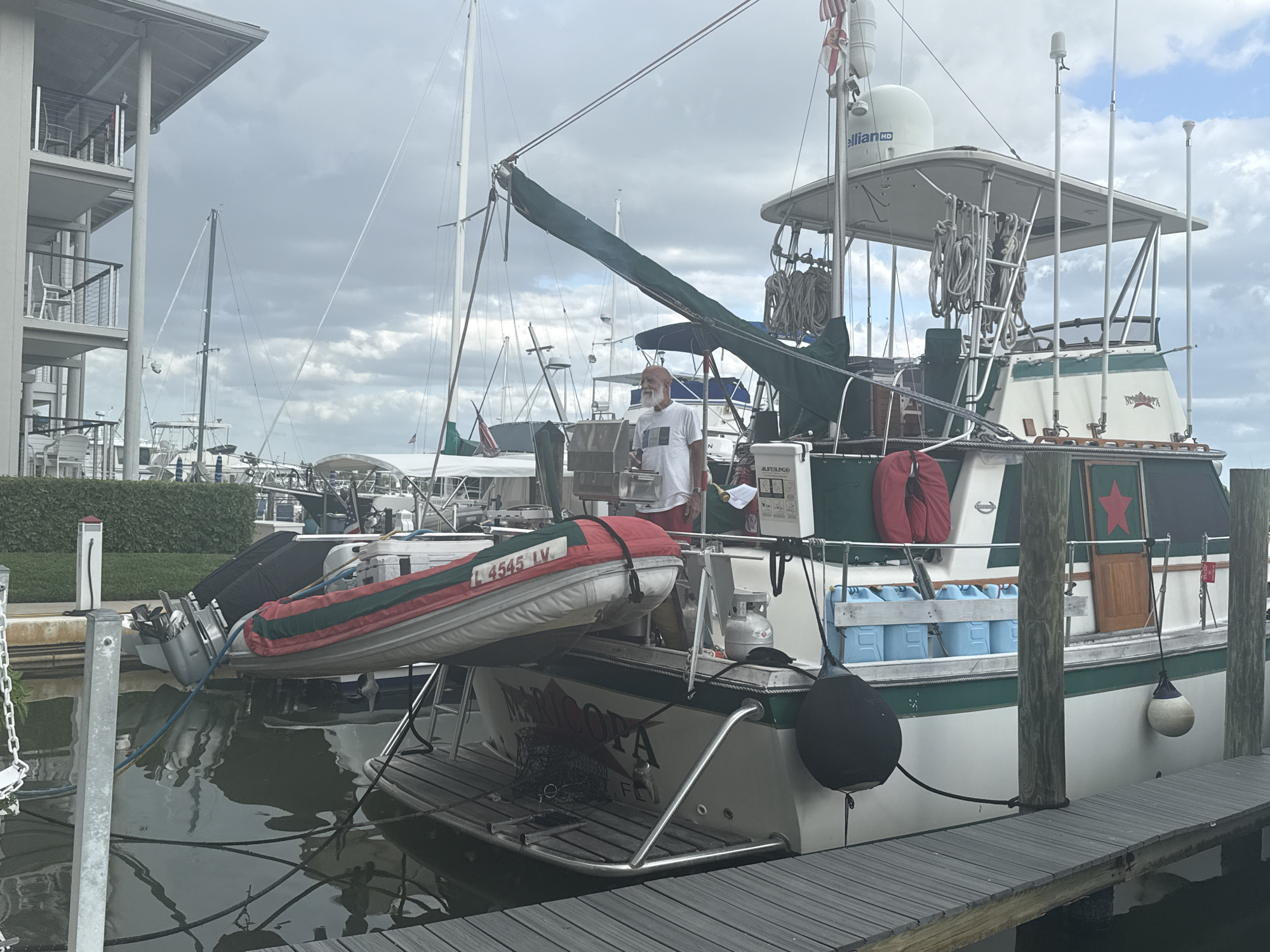 Yacht Maricopa docked at Naples marina with crew activity