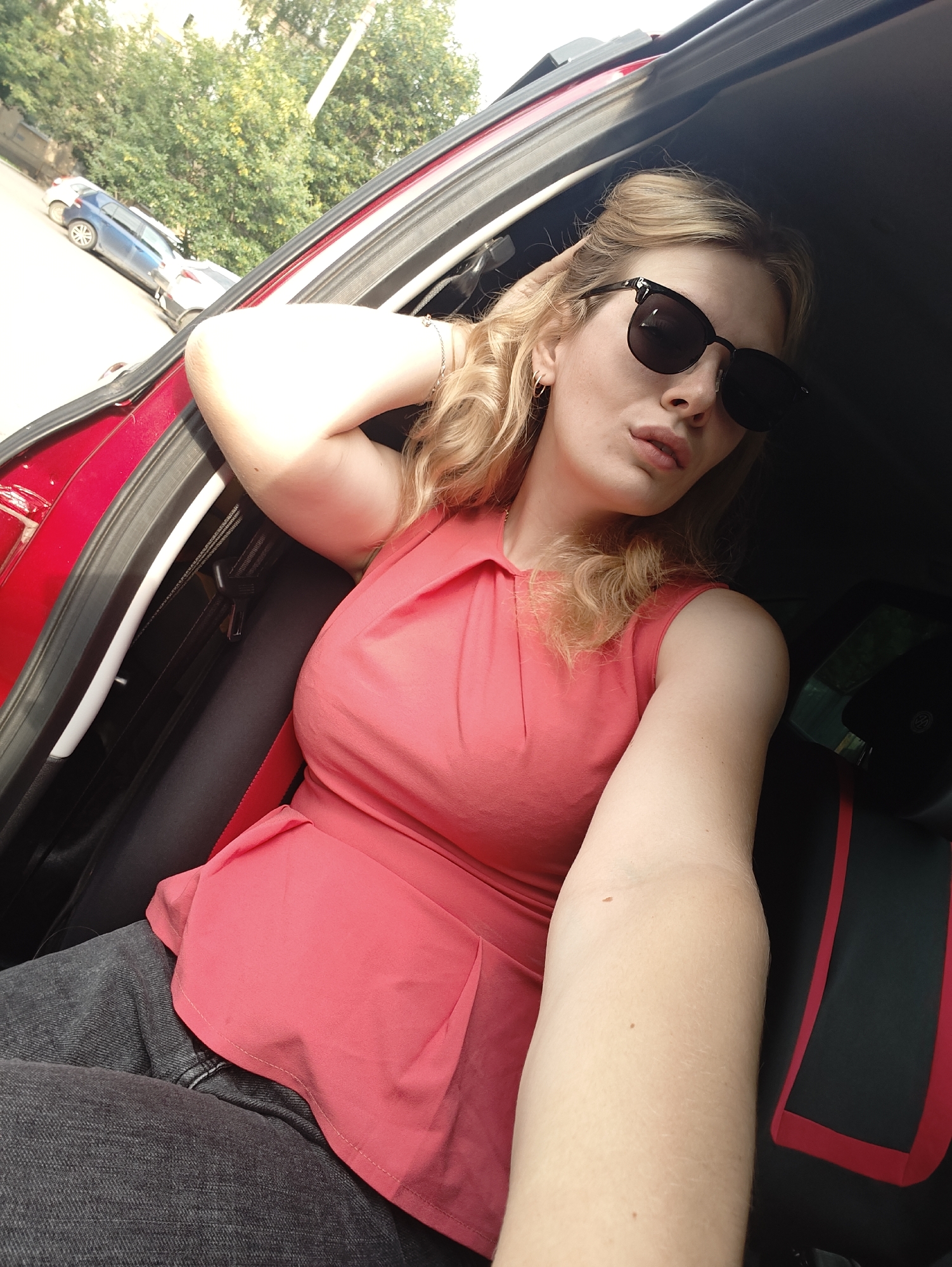 Candid shots in and around a red car in Izhevsk