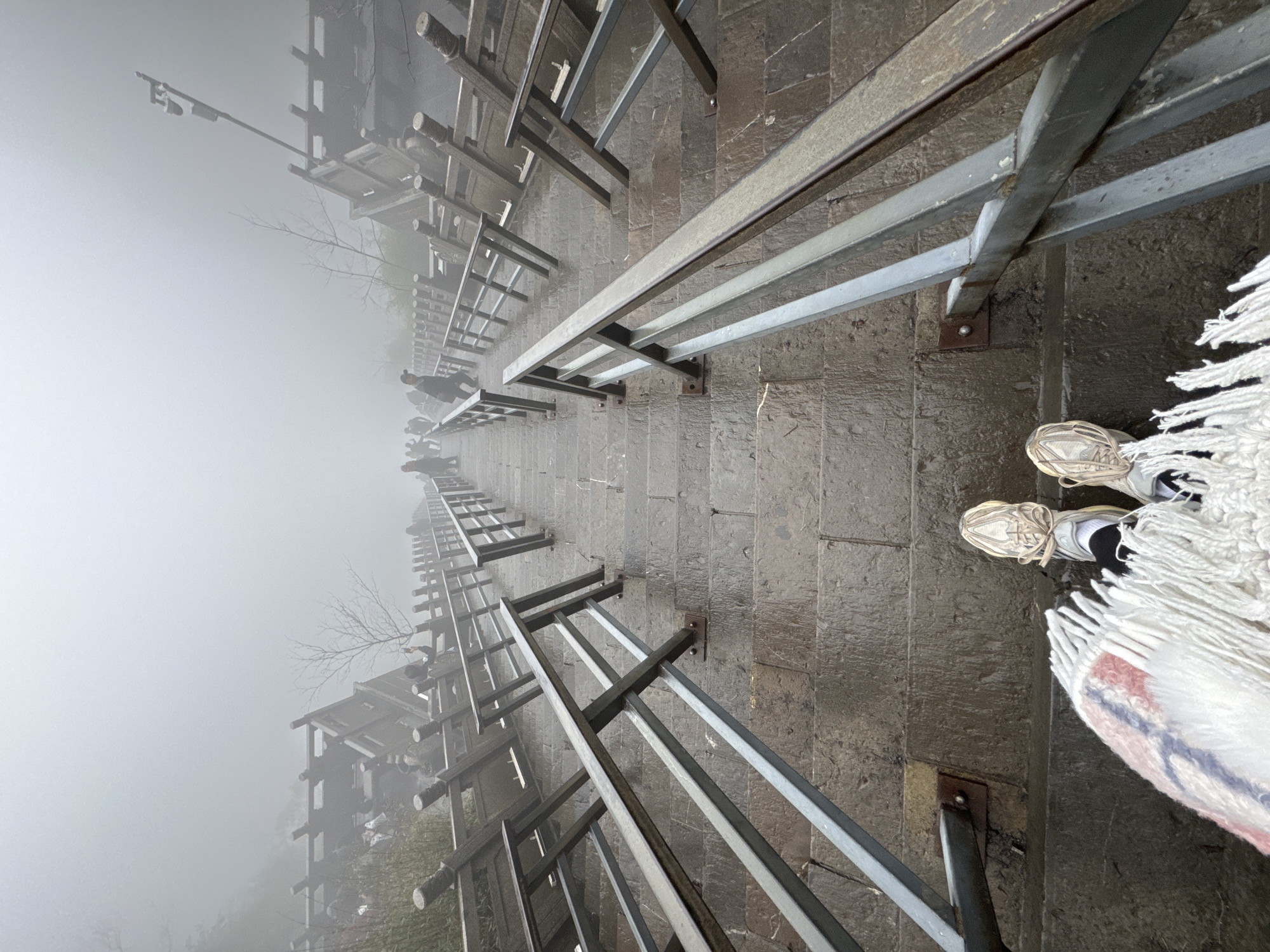 Tourist documents foggy morning exploration of Zhangjiajie's Heavenly Gate Mountain