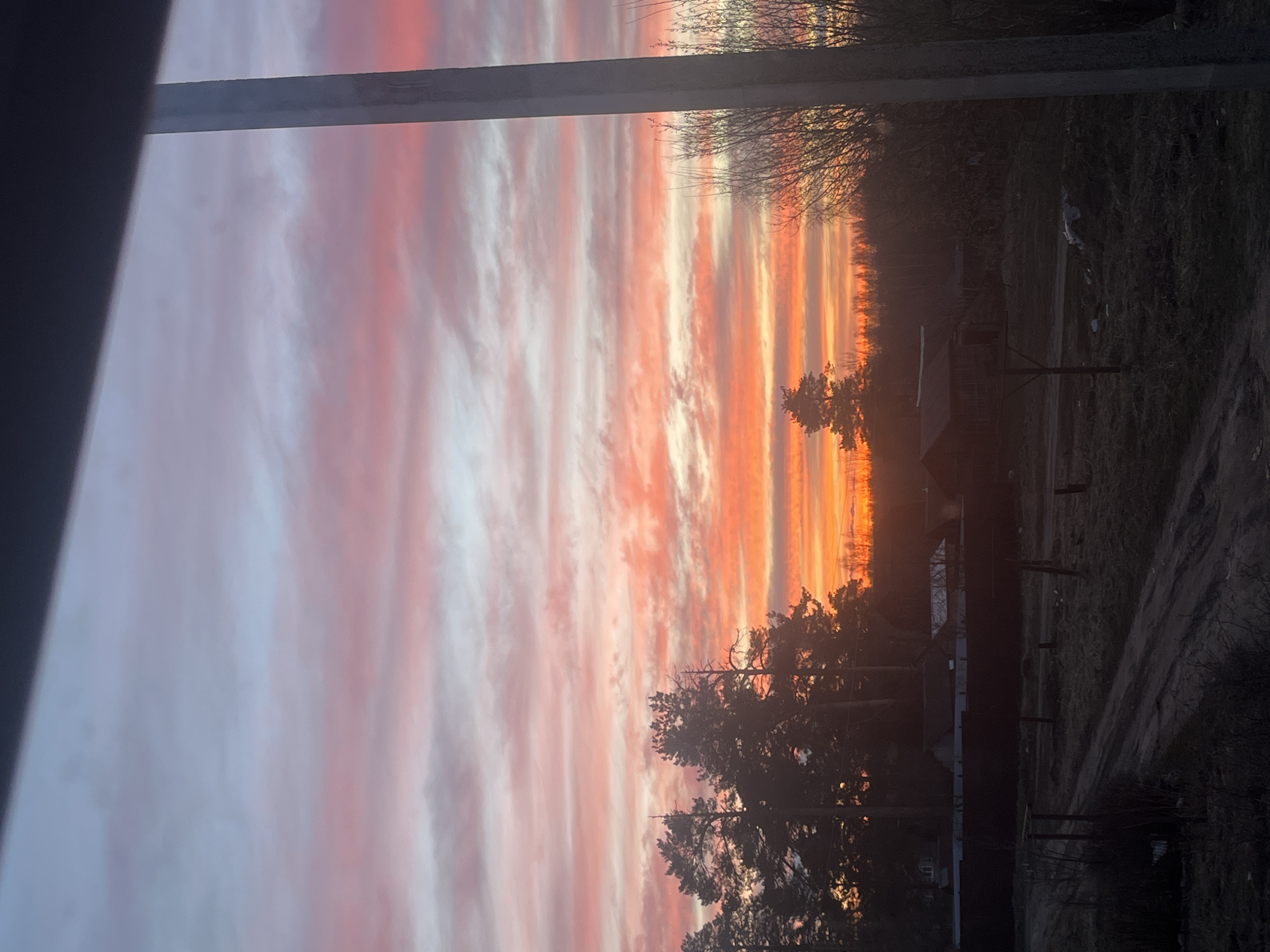 Resident documents colorful sunset in rural Russia village