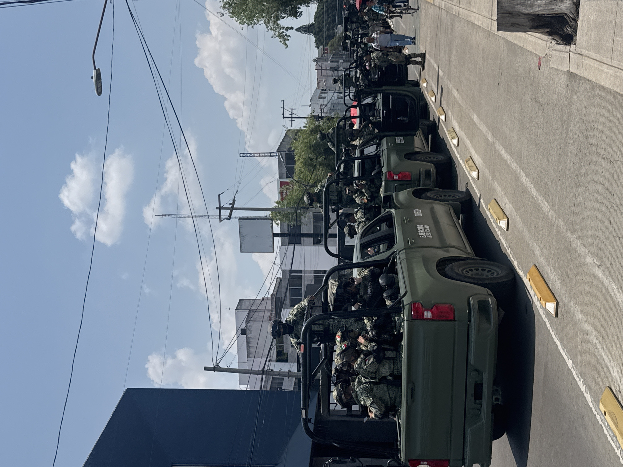 Military formation observed on Puebla street with vehicles, troops