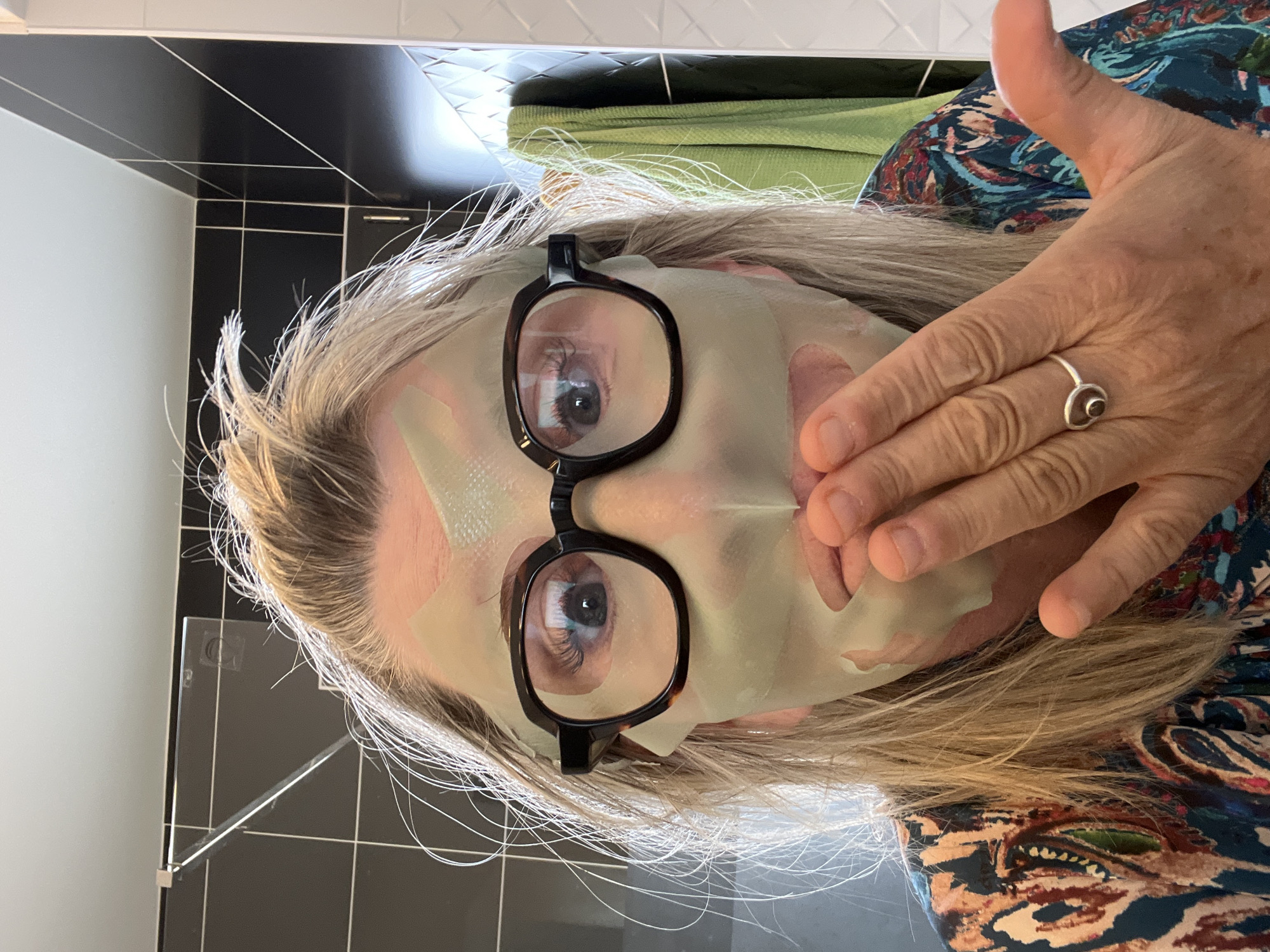 Woman applies facial mask during afternoon skincare routine in France