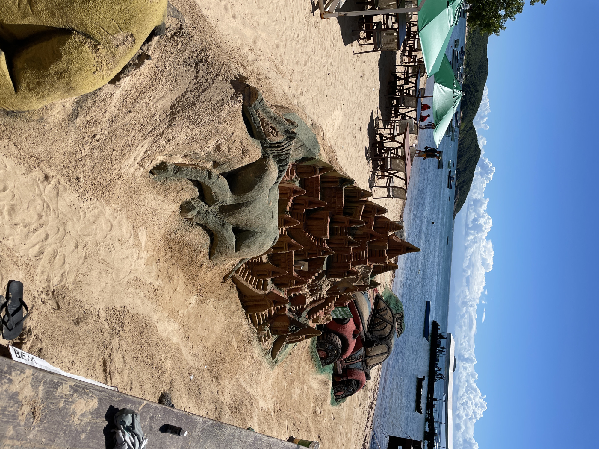 Tourists enjoy beach day with sand sculptures in Búzios
