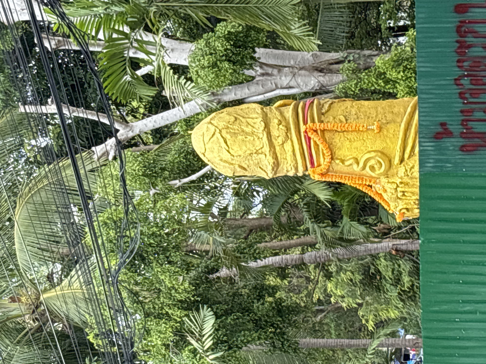 Decorated fertility statue spotted amid tropical vegetation in Thailand