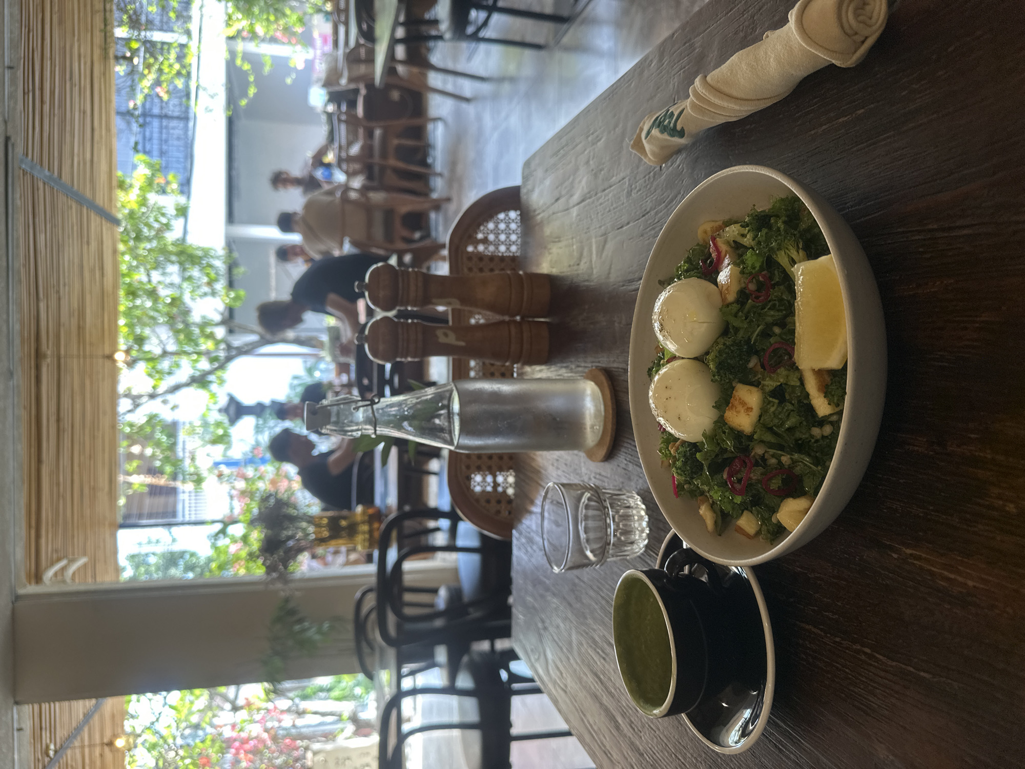 Café breakfast spread: kale salad, poached eggs, and matcha latte