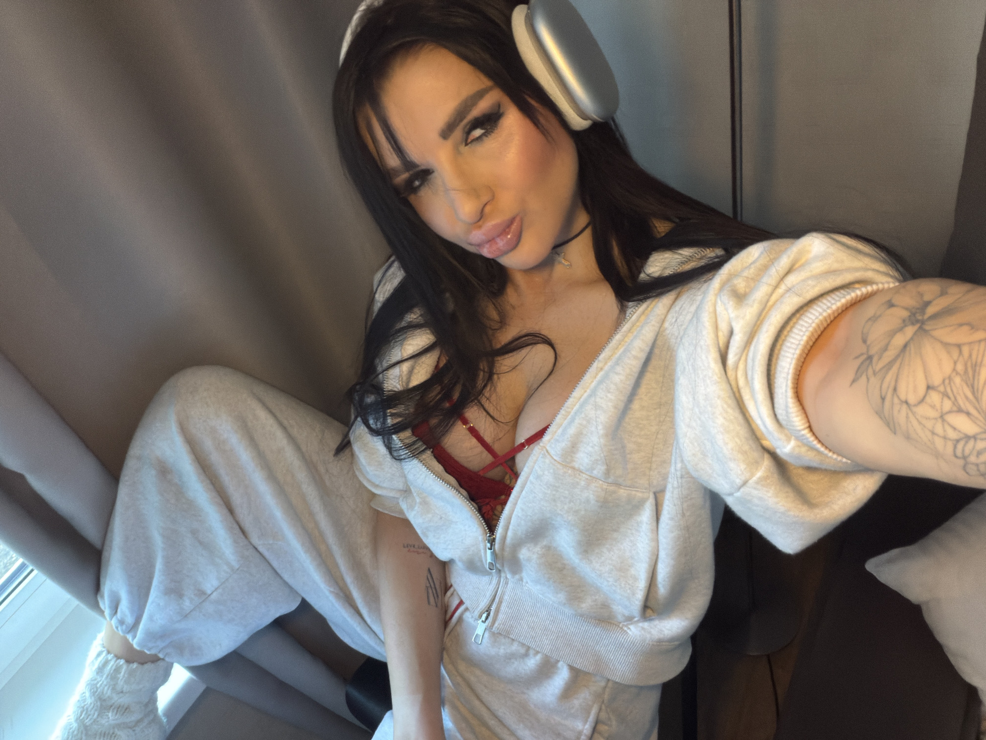 Woman sits indoors in casual attire in Russia