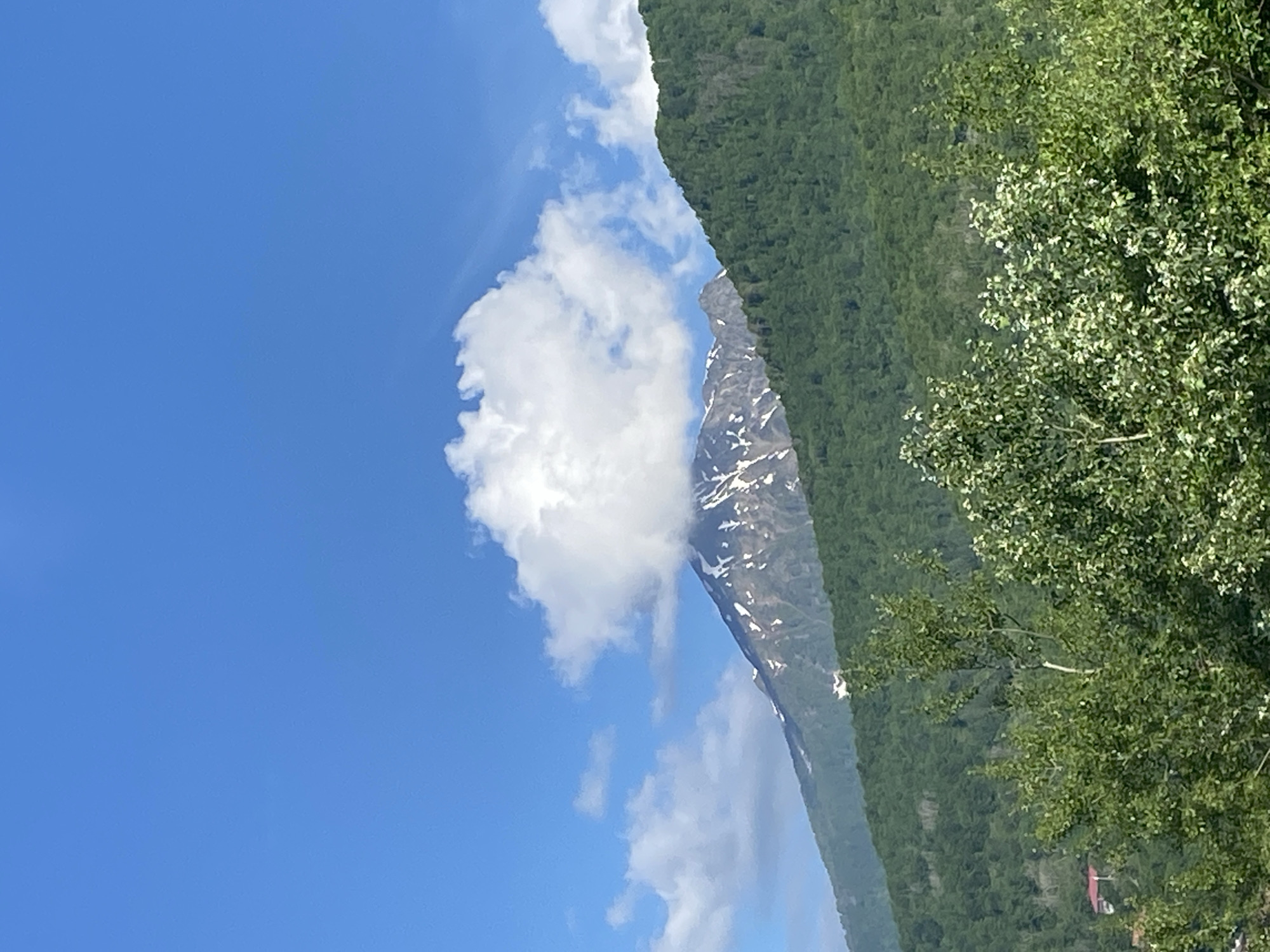 Green mountain landscape observed under clear skies in Estosadok