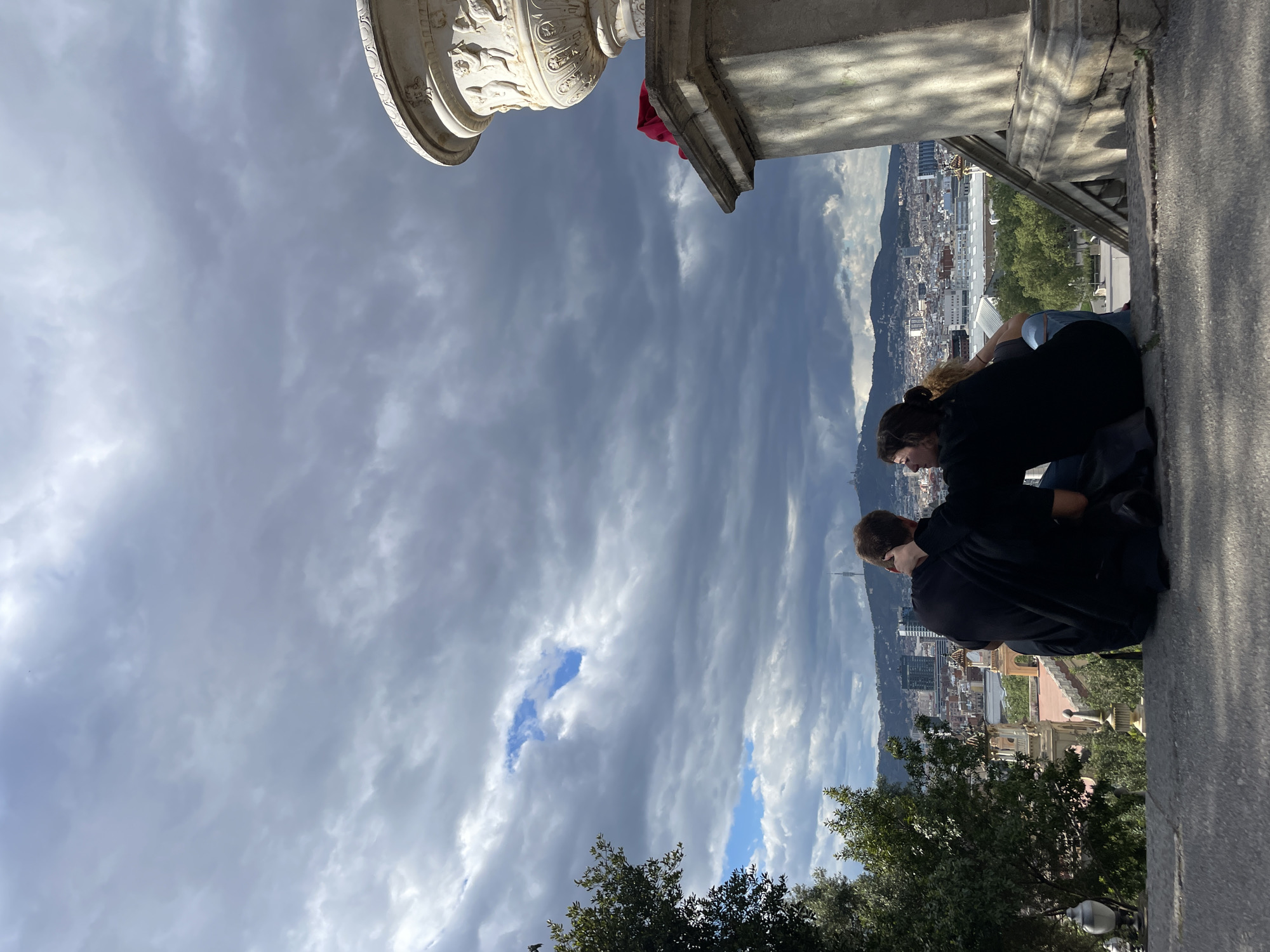 Tourists, street musician gather at Barcelona museum viewpoint afternoon