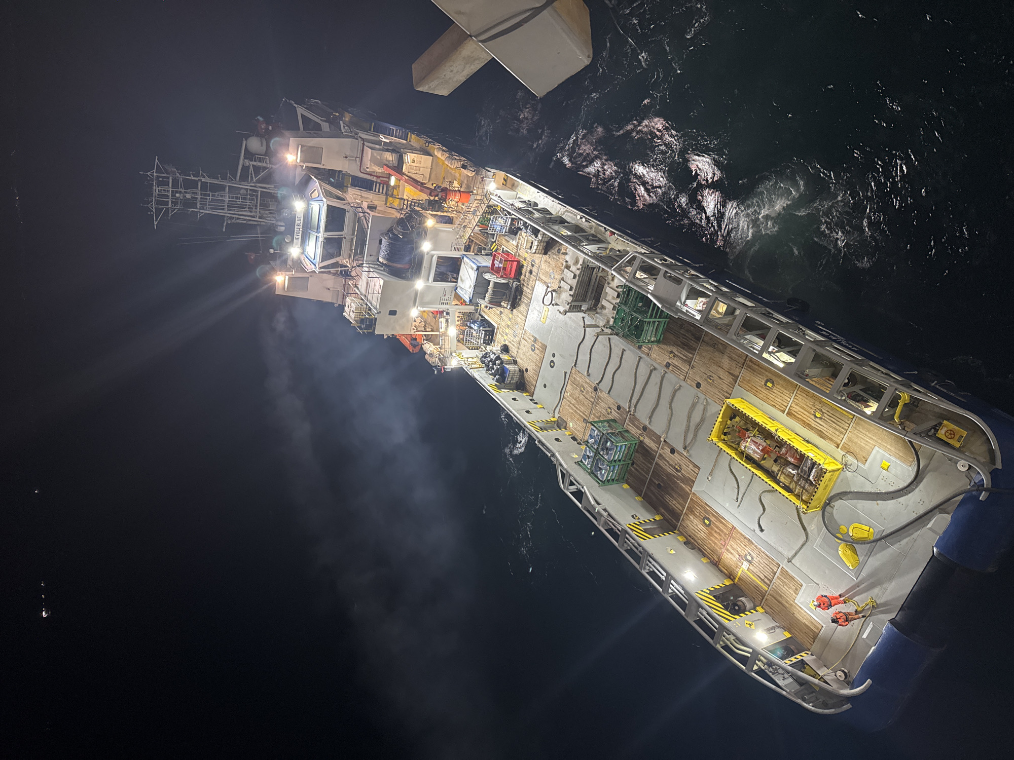 Cargo ship spotted at night in turbulent Italian waters