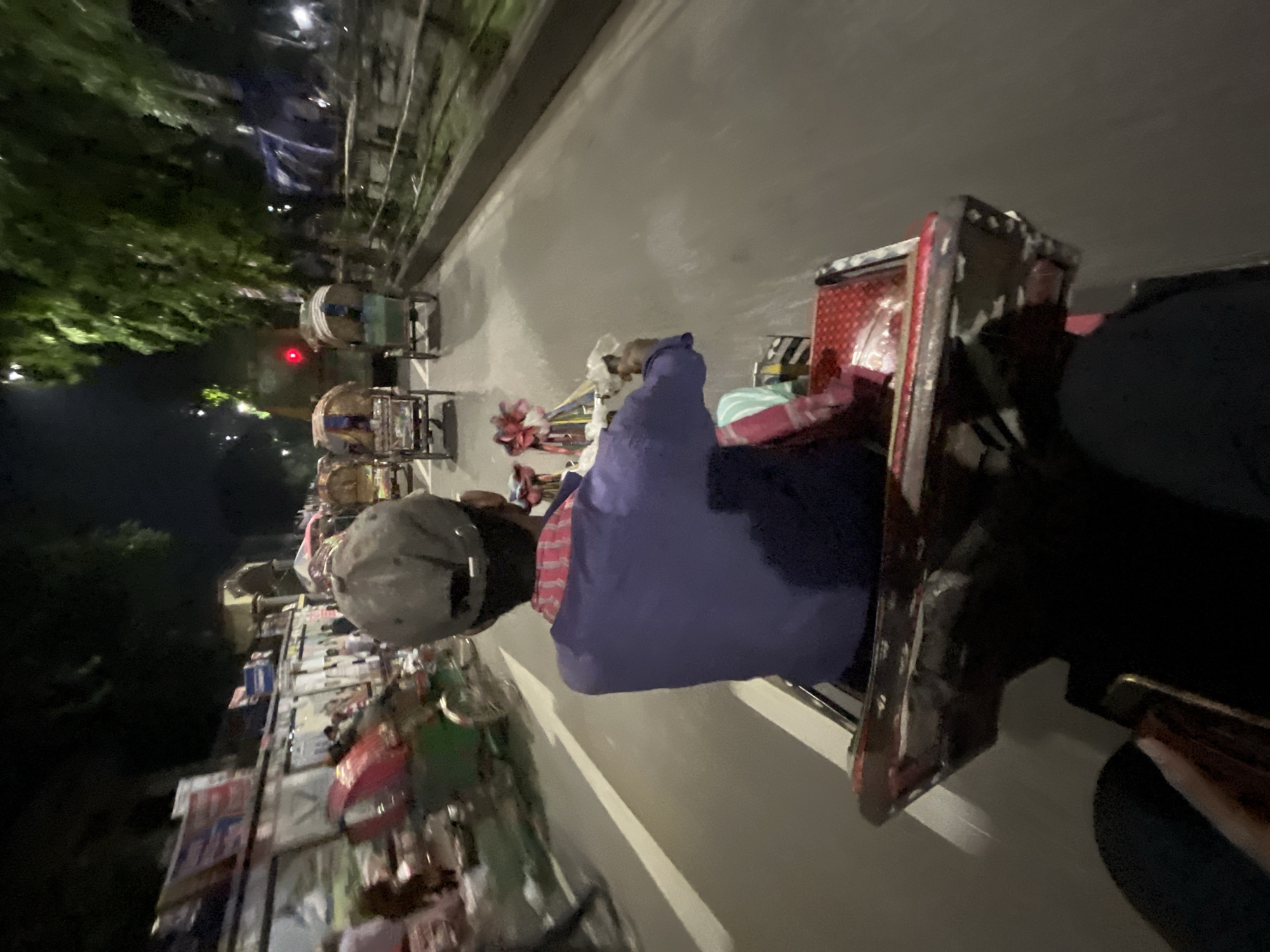 Rickshaw rider travels through Dhaka streets in afternoon