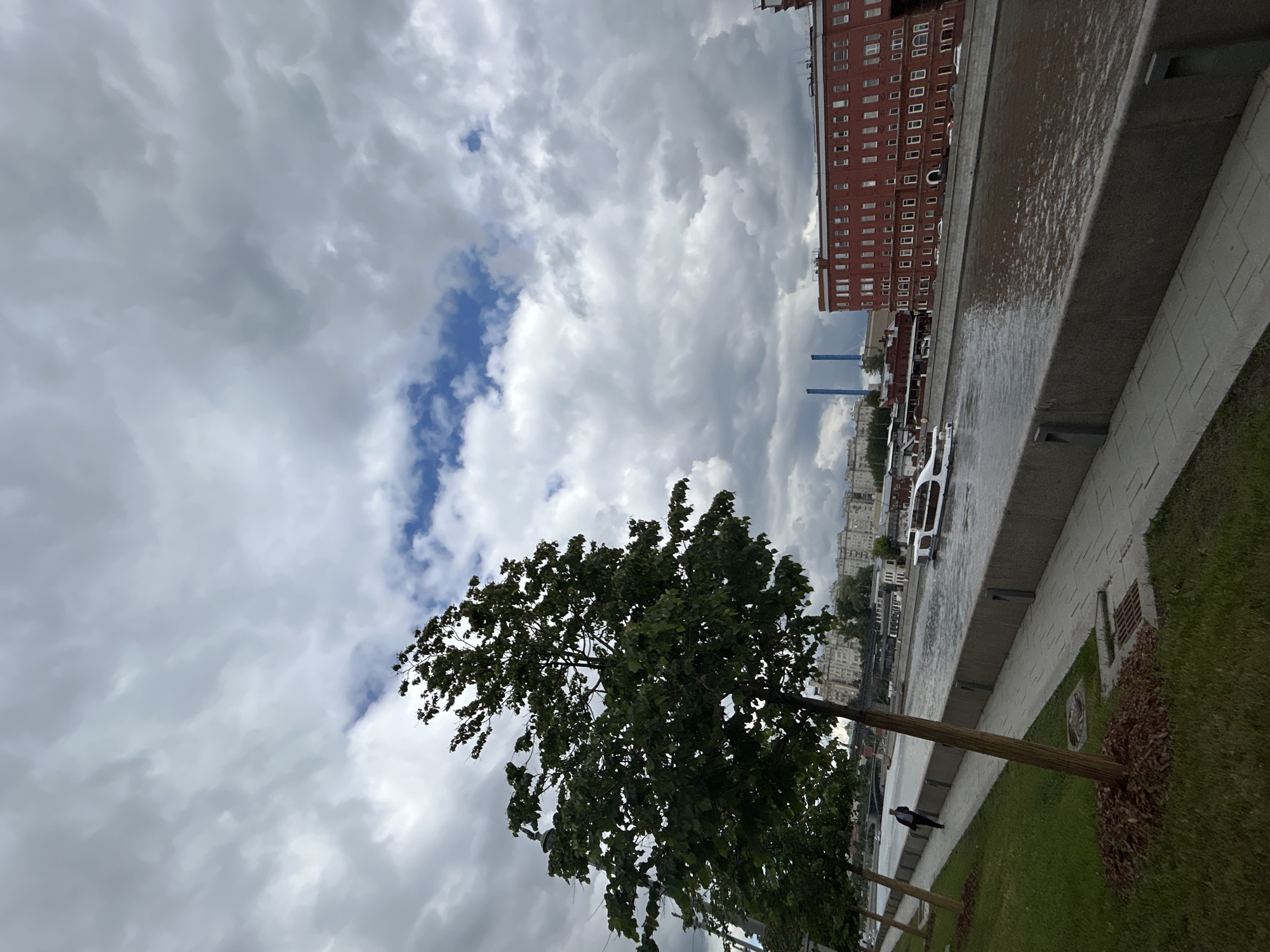 Morning life along Moscow's river embankment under cloudy skies