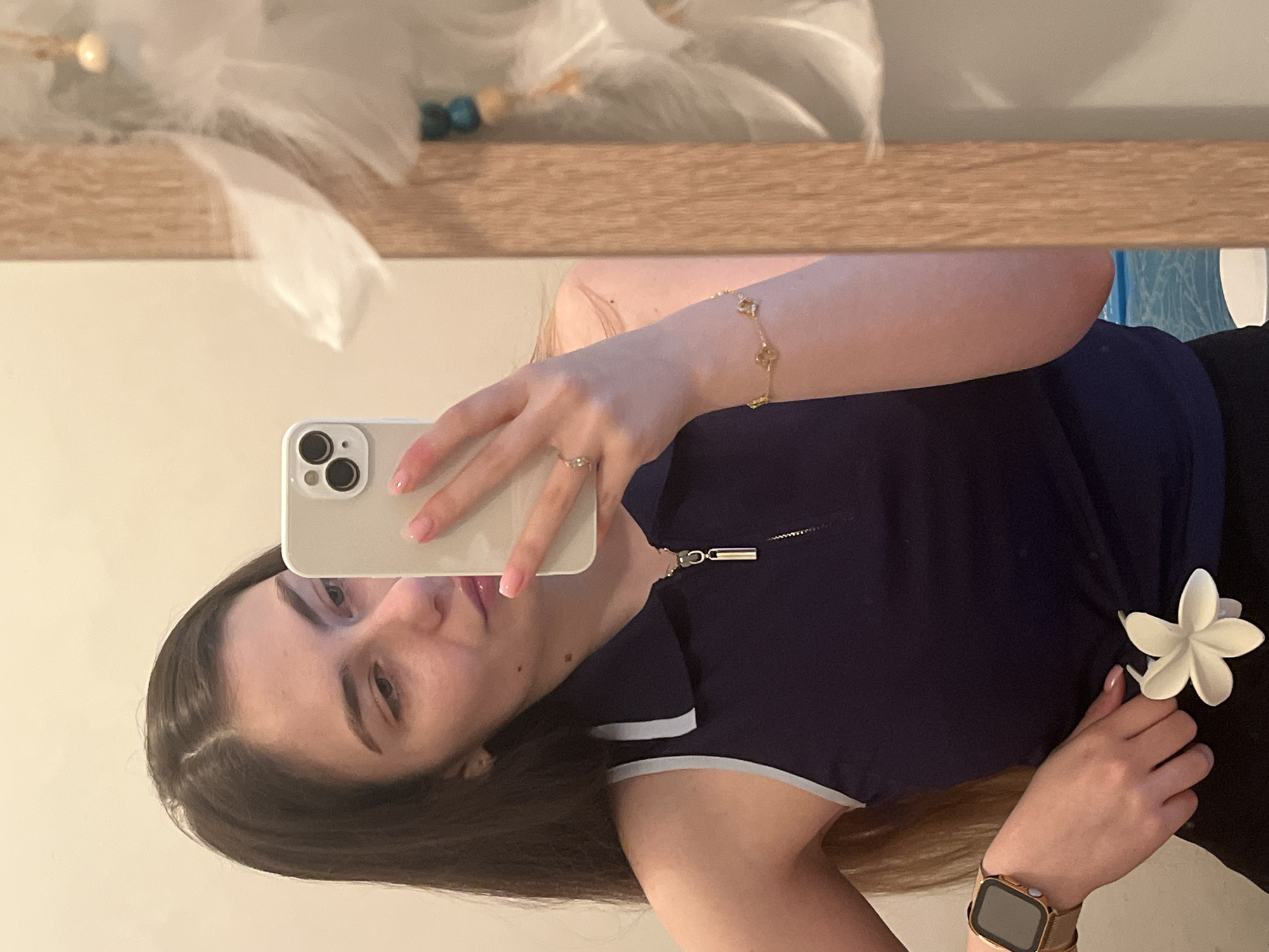 Woman documents mirror selfie session in home setting