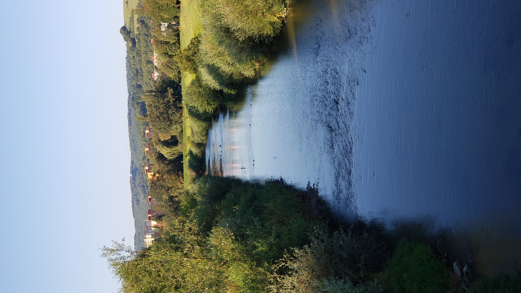 Calm river winding through lush greenery near Prešov, Slovakia