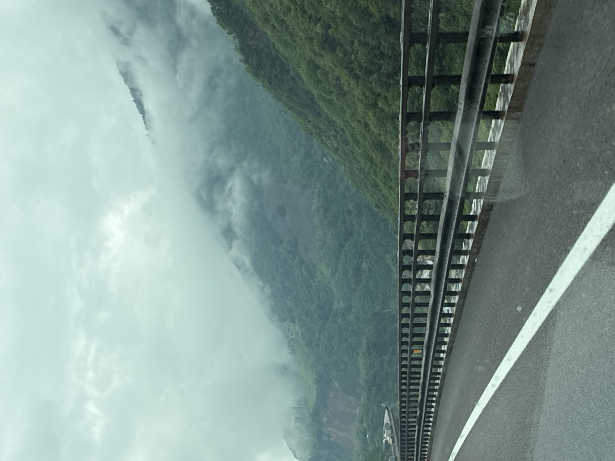 Morning fog observed from roadway in Italian Alpine village