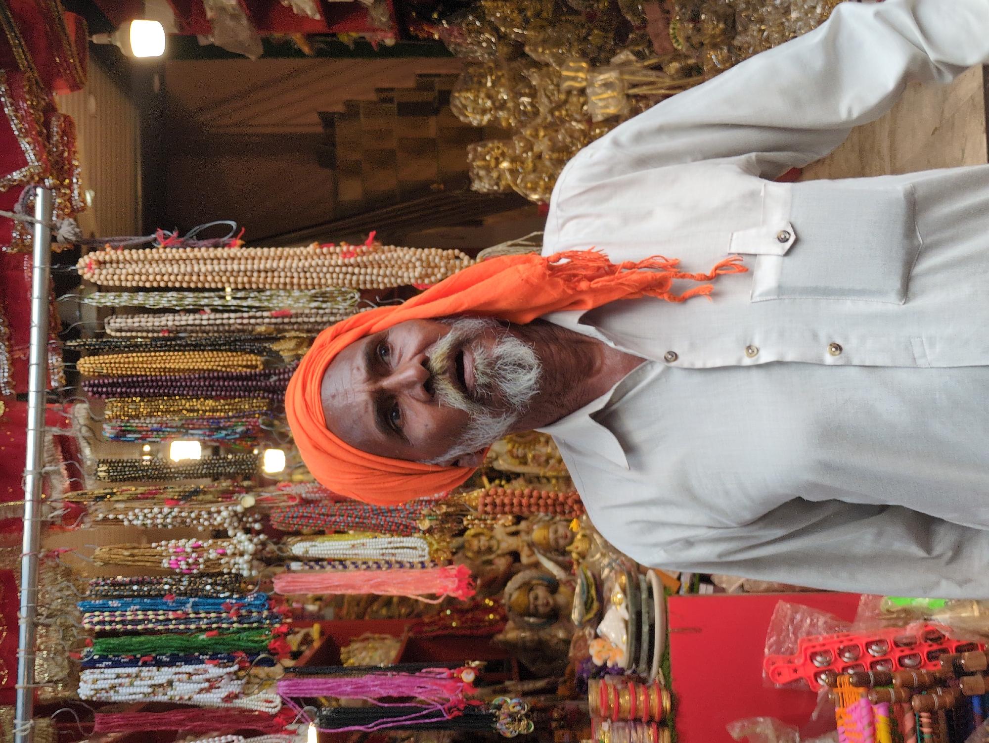 Kangra street market with vendors, shoppers, and henna work