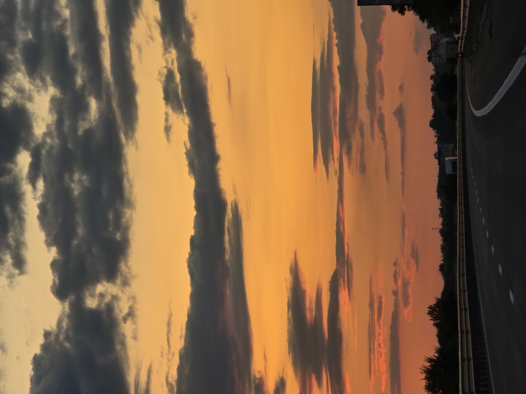 Bulgarian highway curves under a vivid sunset sky