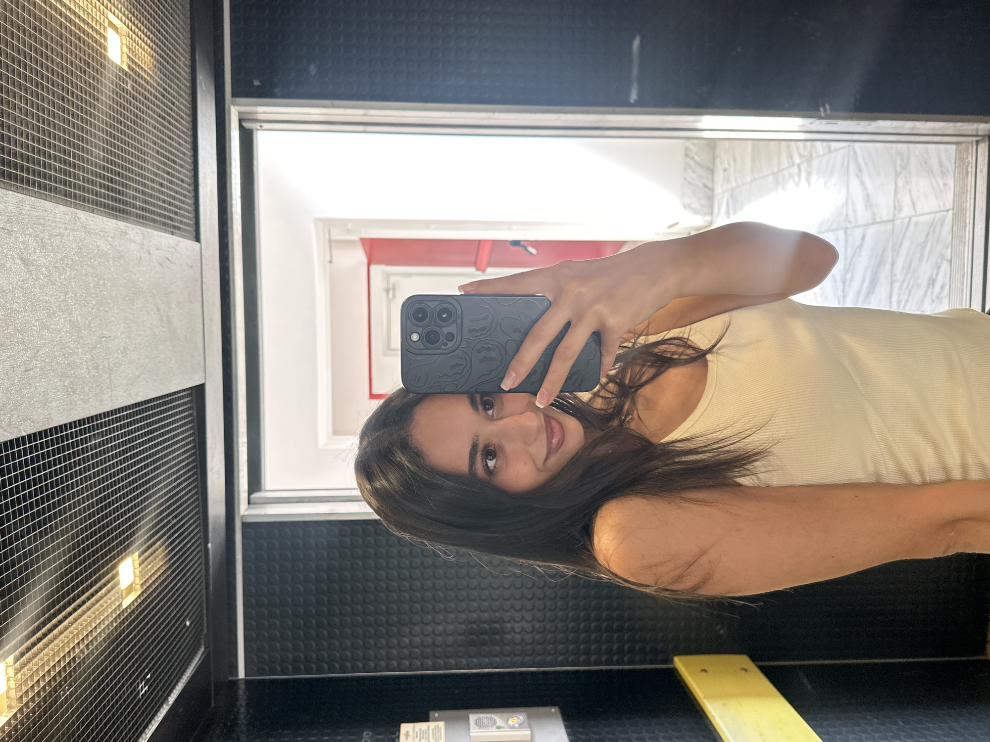 Woman takes selfies in Milan elevator, enjoys cookie break