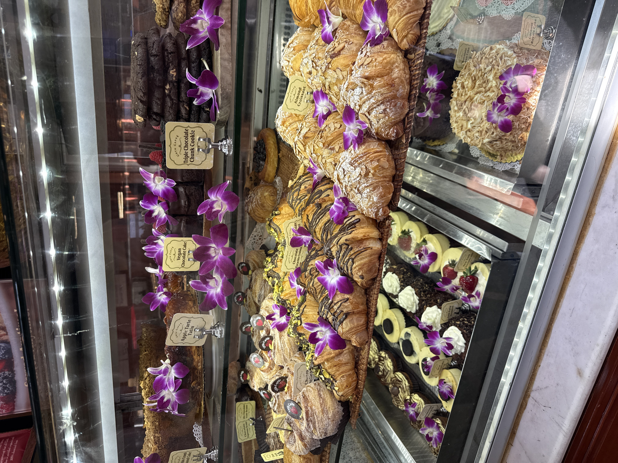 Customer documents pastries and desserts at Beverly Hills café
