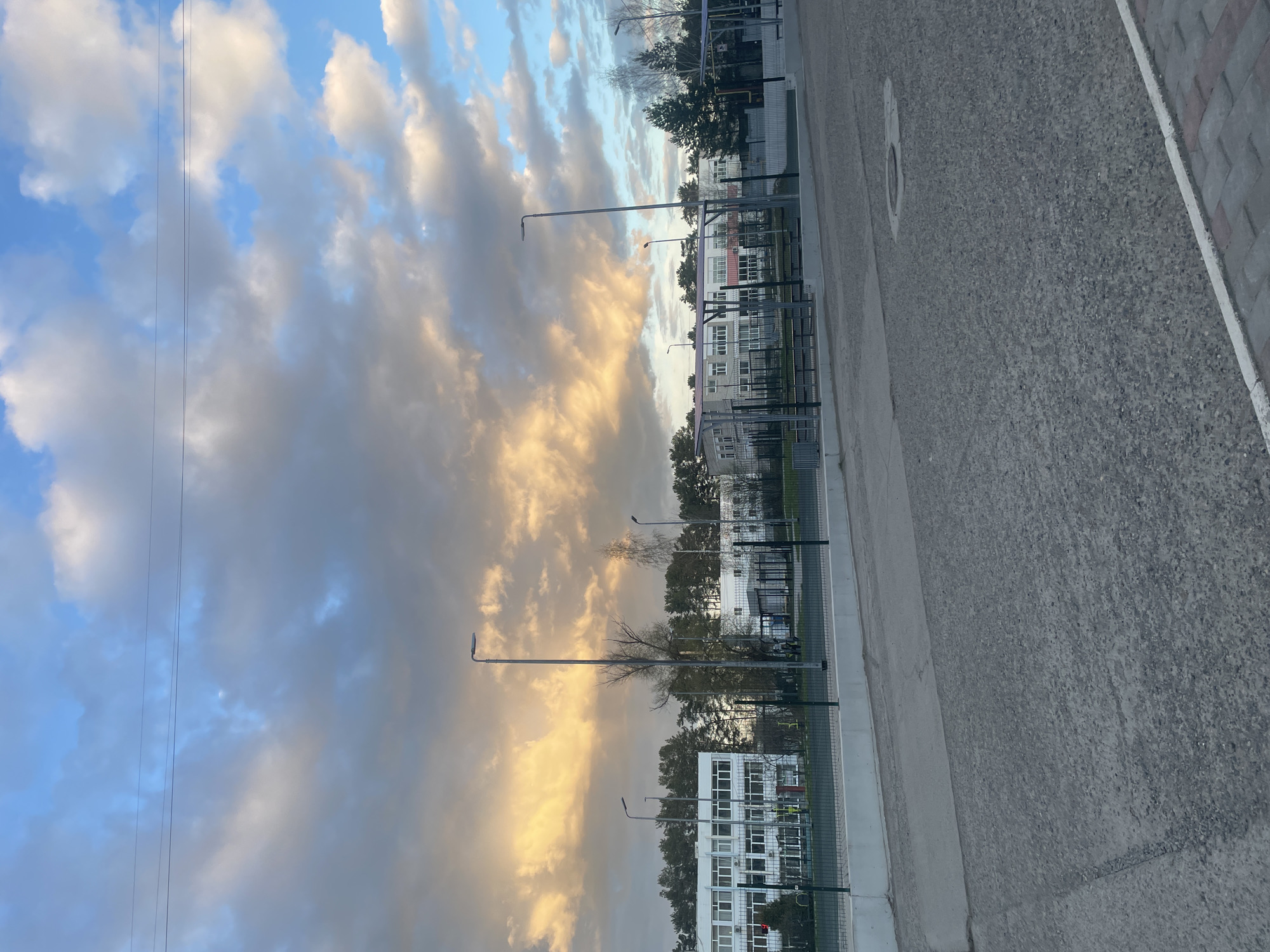 Roadside landscape captured showing dramatic sky over urban area