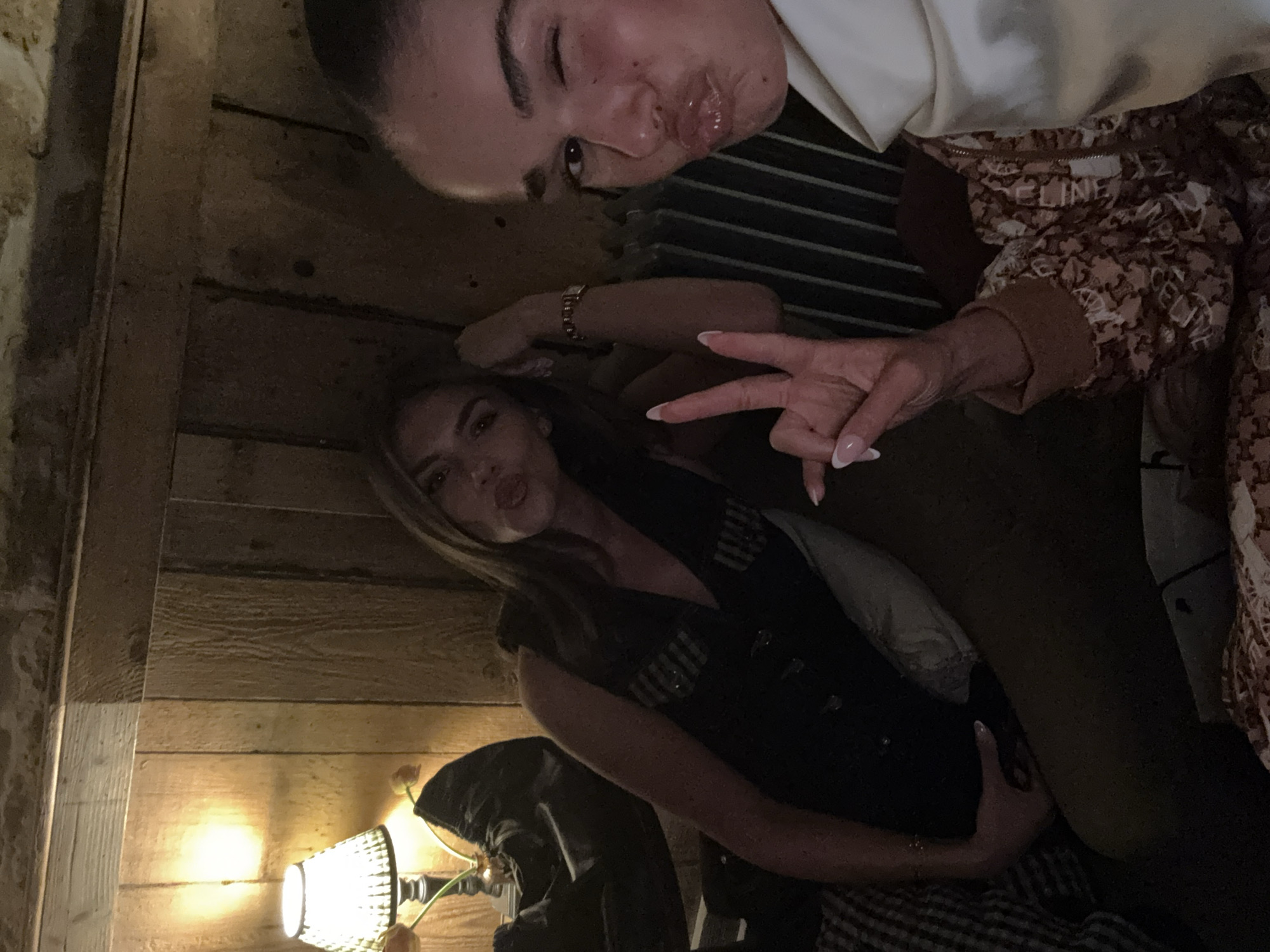 Two women take selfie indoors in West Oxfordshire evening
