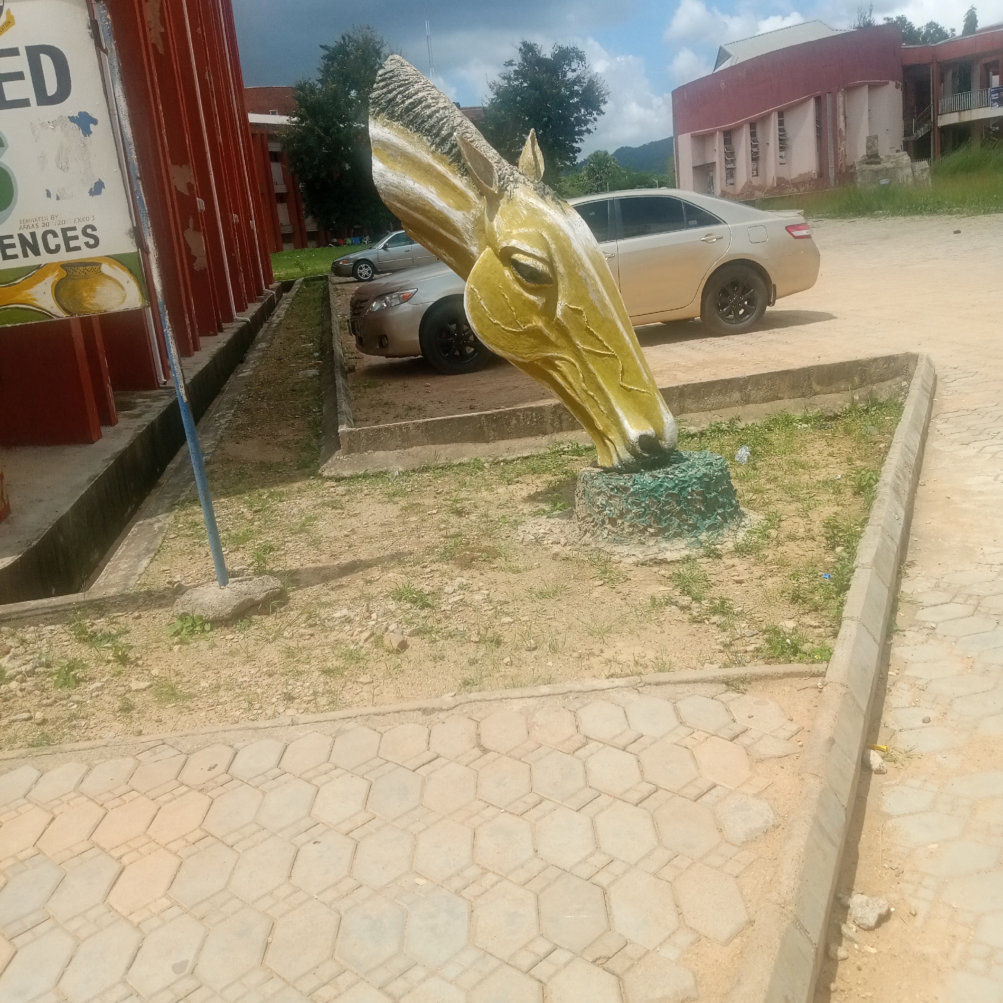 Campus sculptures and a lively outdoor event in Jos, Nigeria
