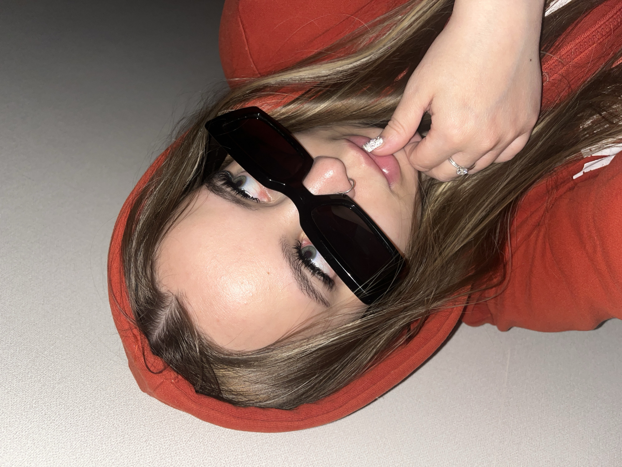 Person in orange hoodie photographed relaxing indoors in Krasnodar