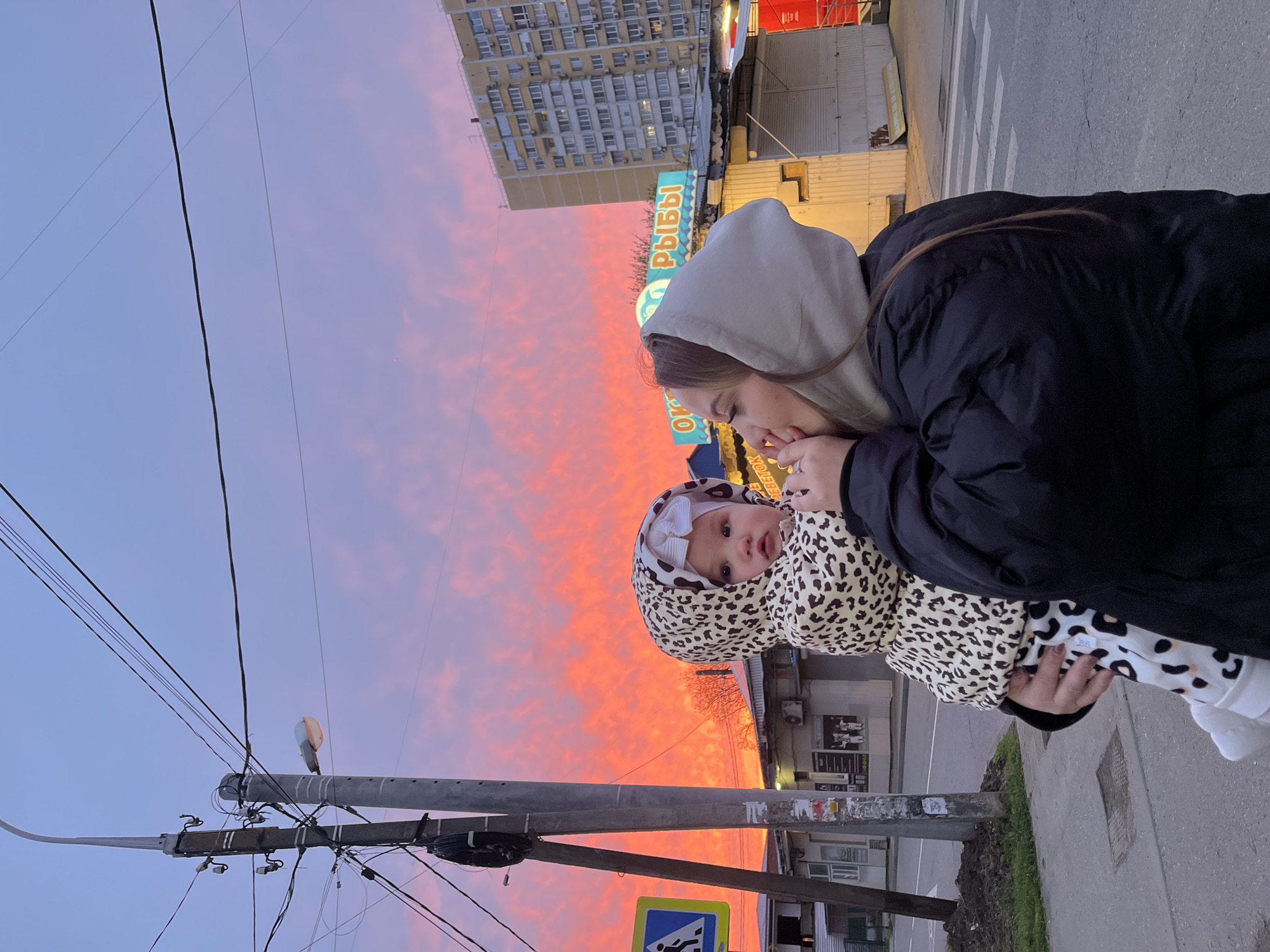 Woman and baby share tender moment during Krasnodar sunset