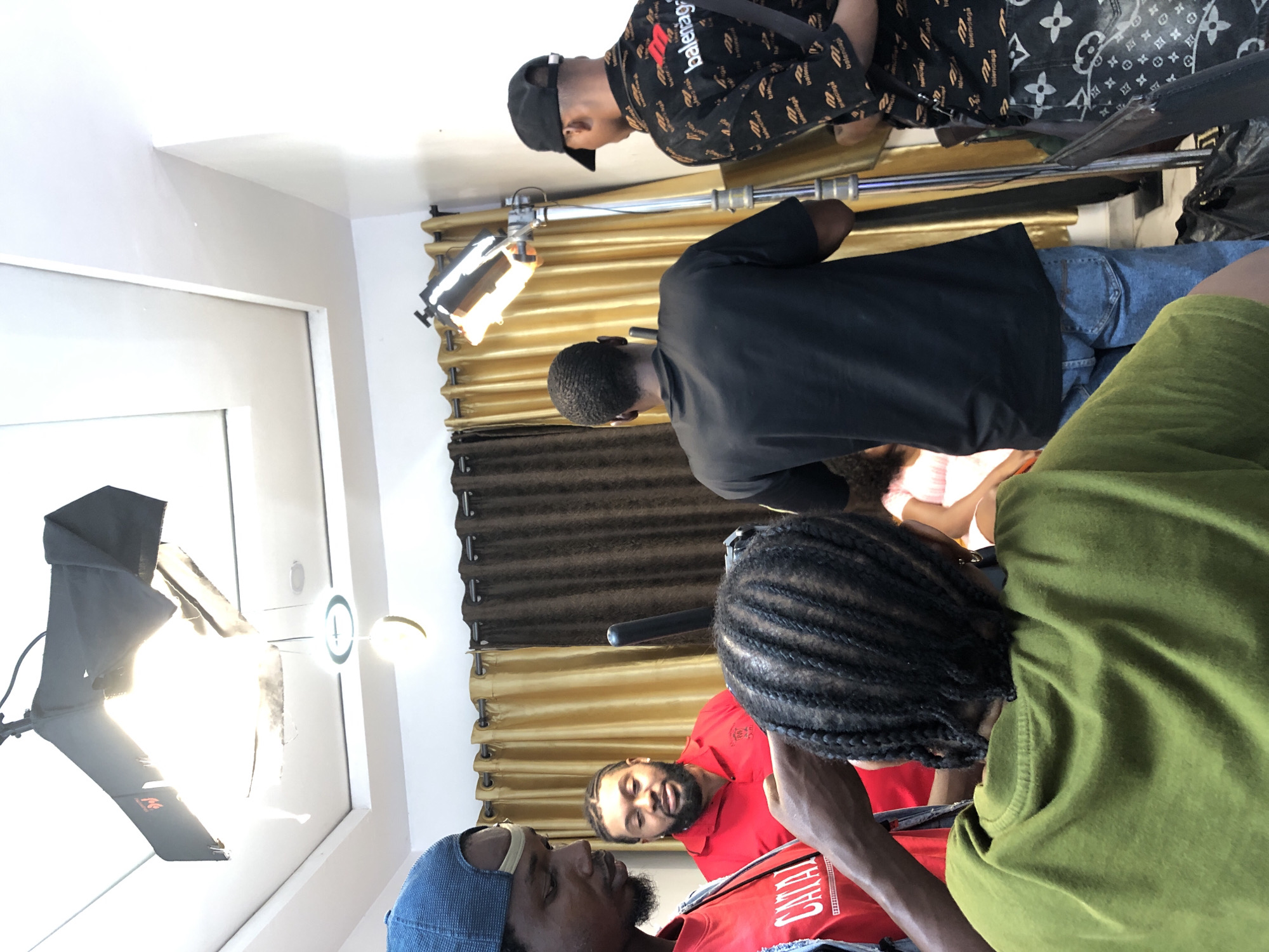 Film production documented with crew and lighting equipment