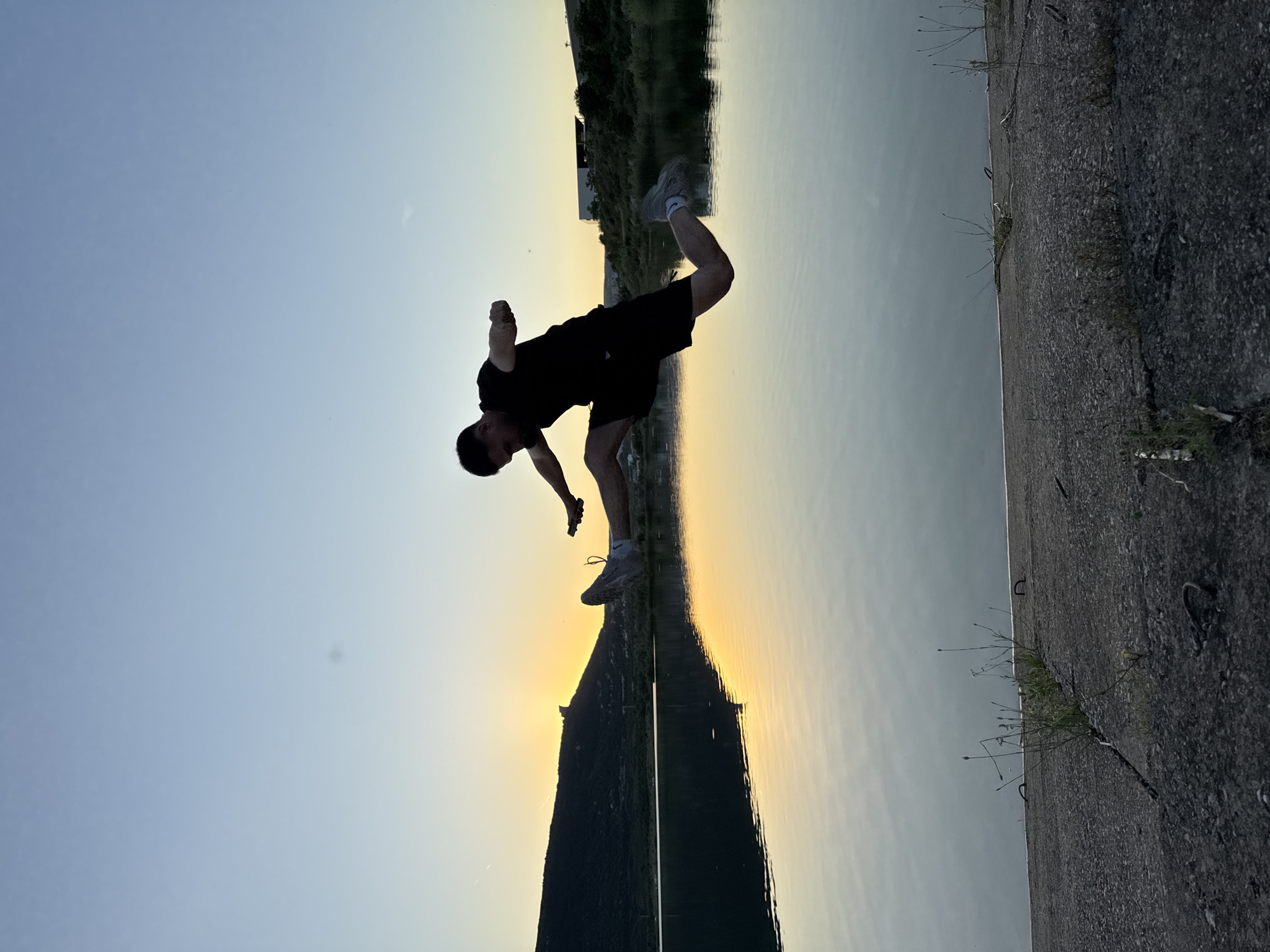 Jumping and flipping at a Shumen lakeside during golden hour