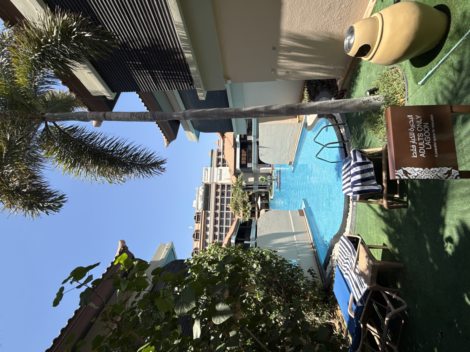 Tourist documents sunny morning walk through Dubai resort complex