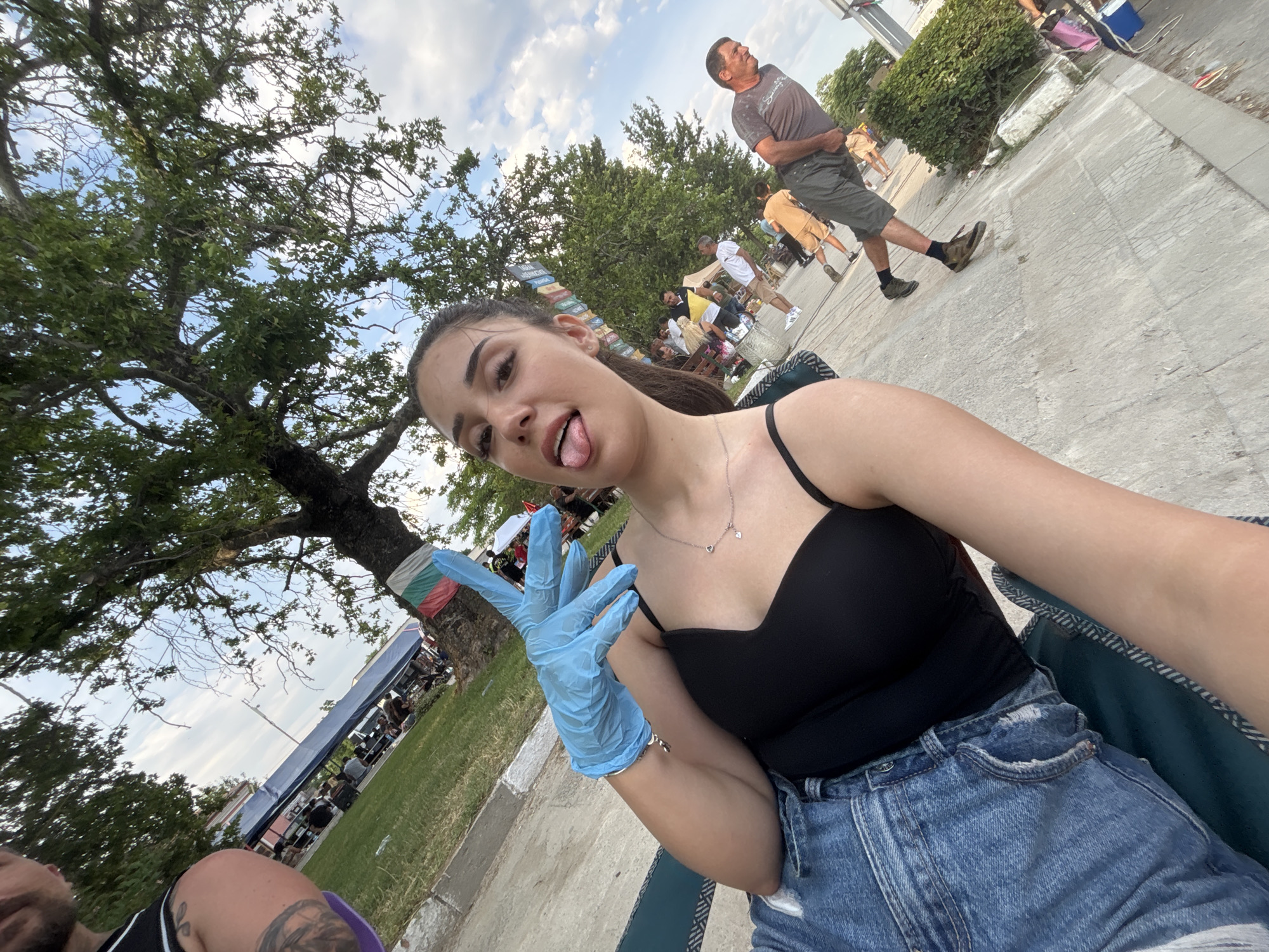 Woman takes selfies at outdoor market in Kostievo, Bulgaria