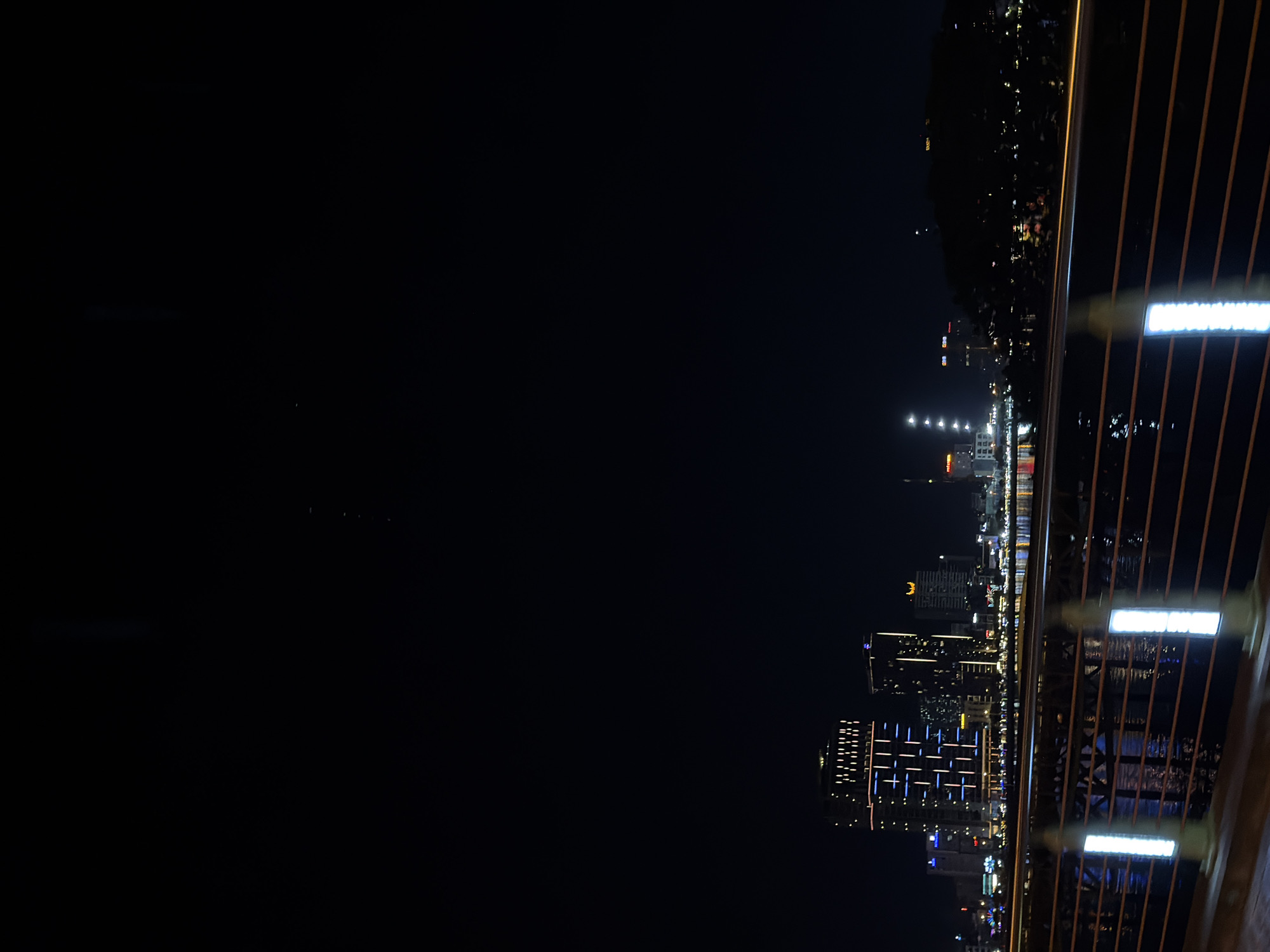 Da Nang at night: bridges, neon signs, and scooter traffic