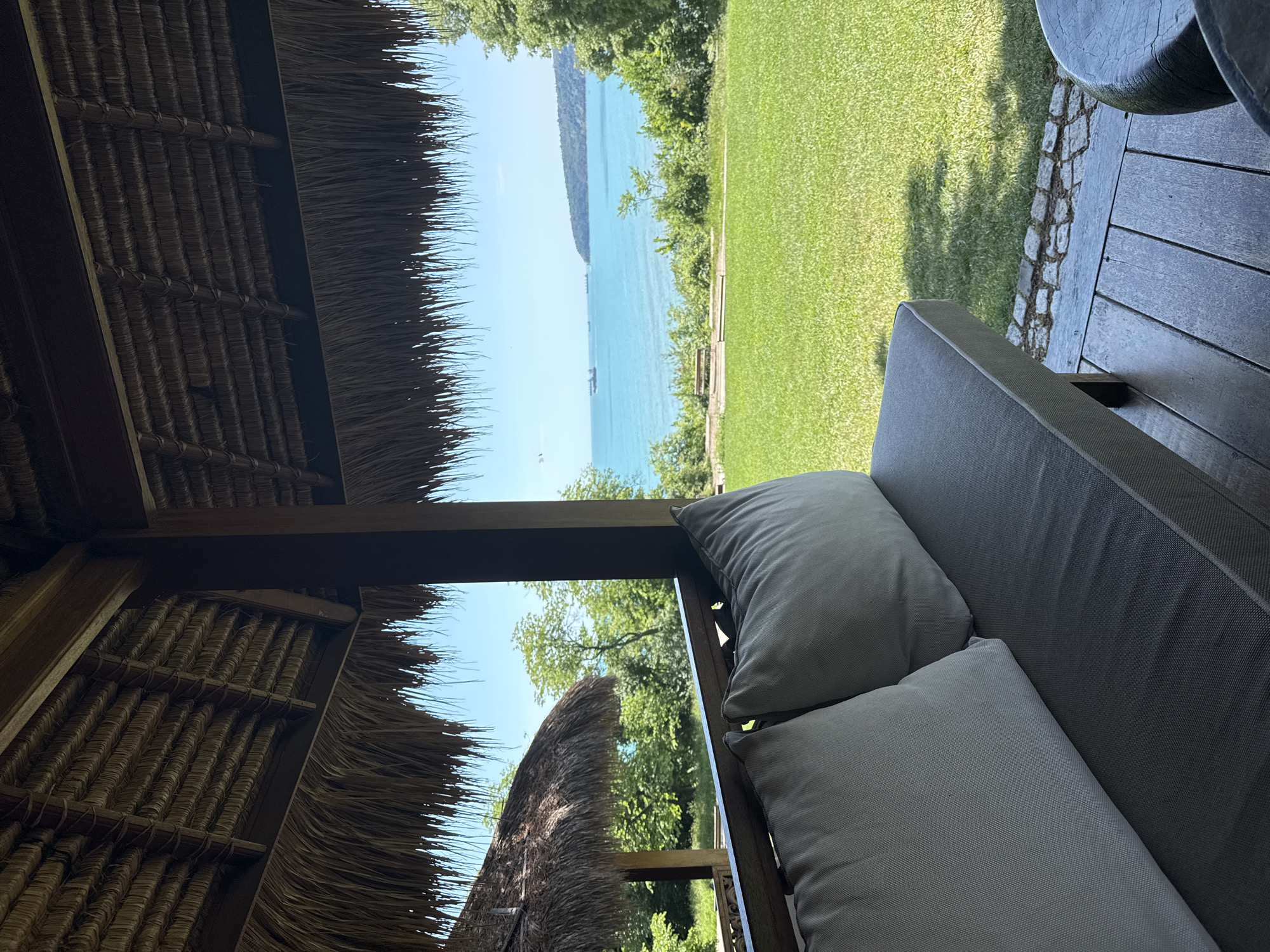 Coastal view captured from beneath thatched roof structure