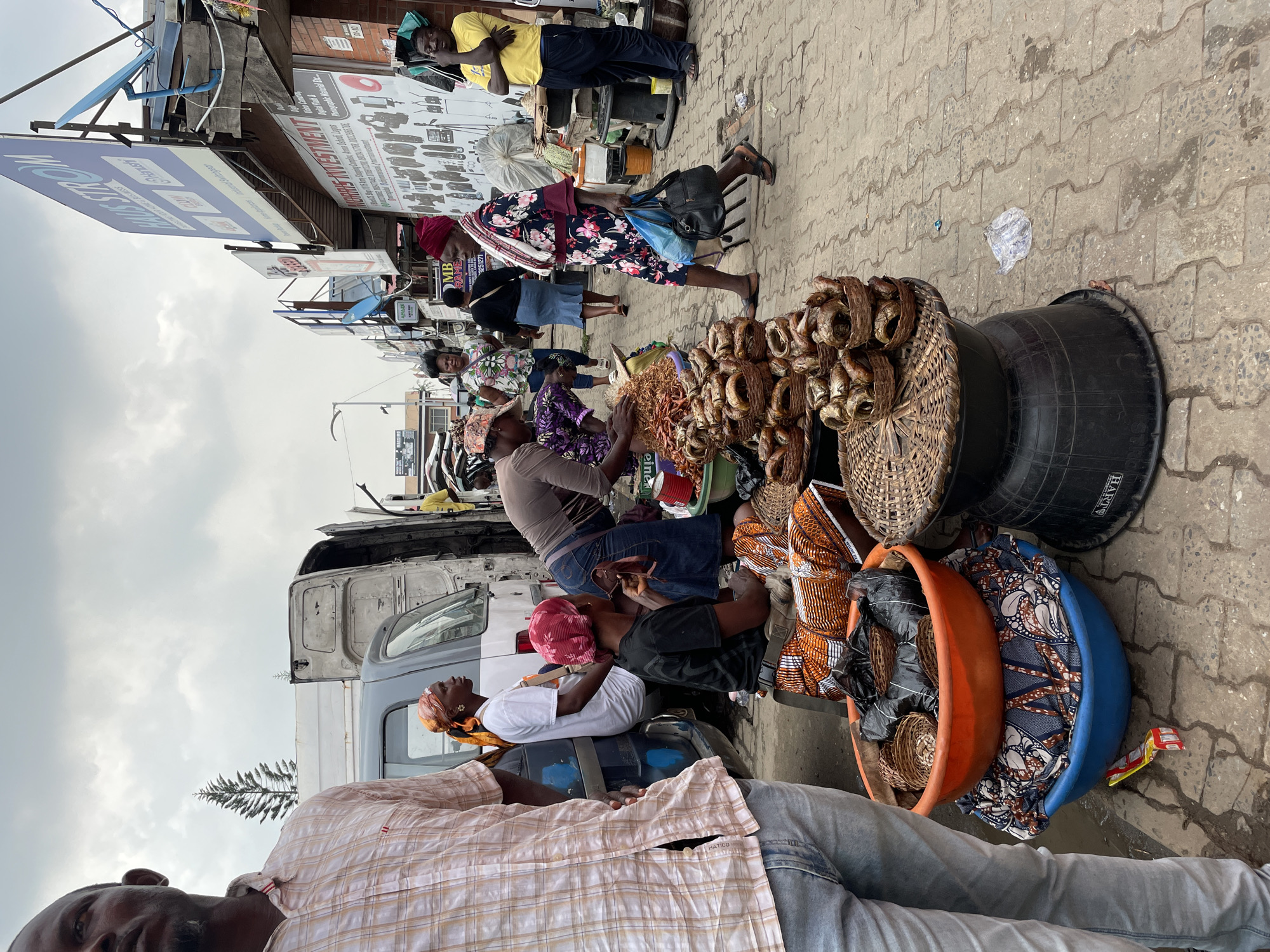 Street vendors sell goods at Ikeja marketplace