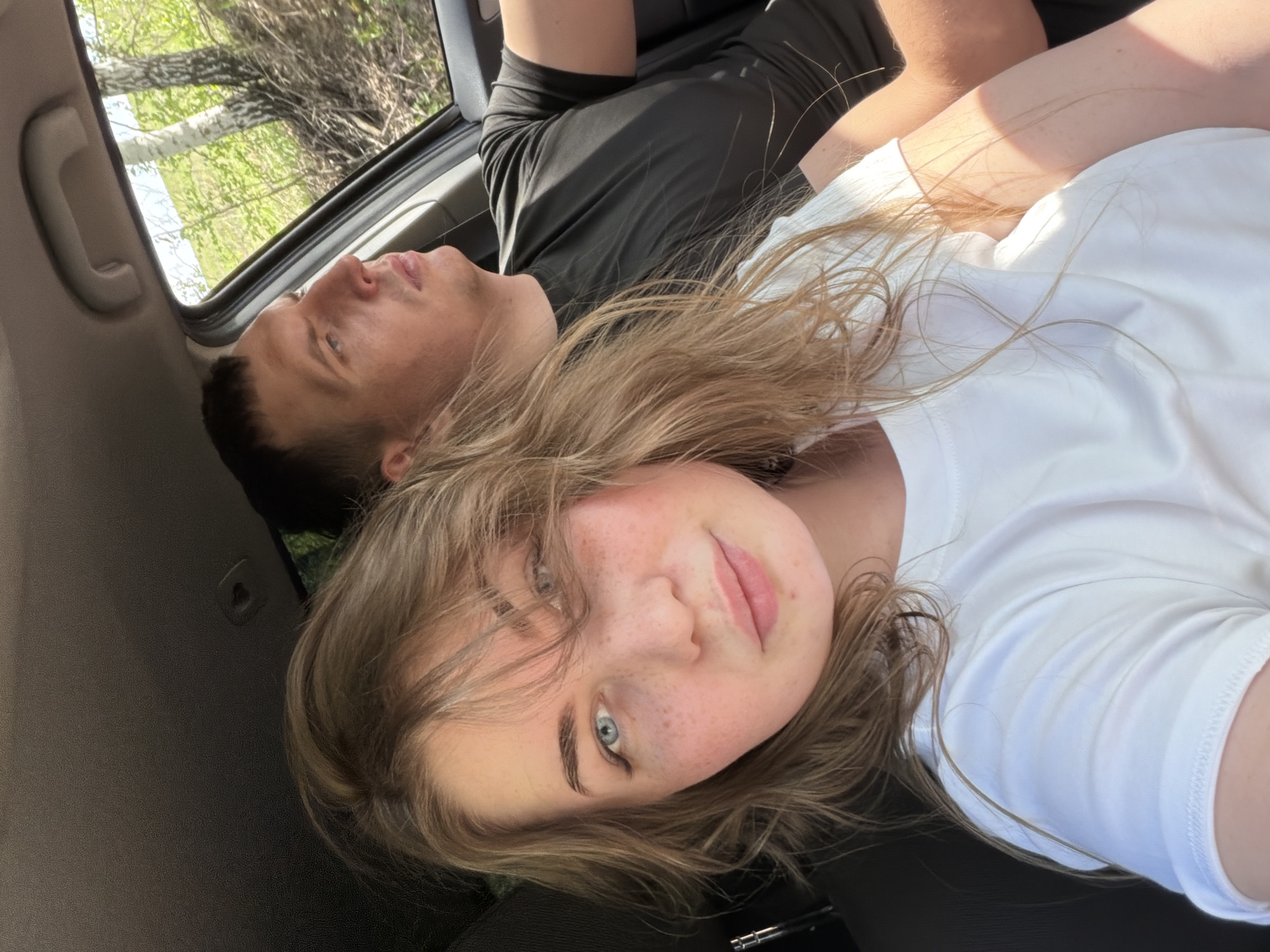 Two people take selfie in vehicle in Ural'skoe, Russia