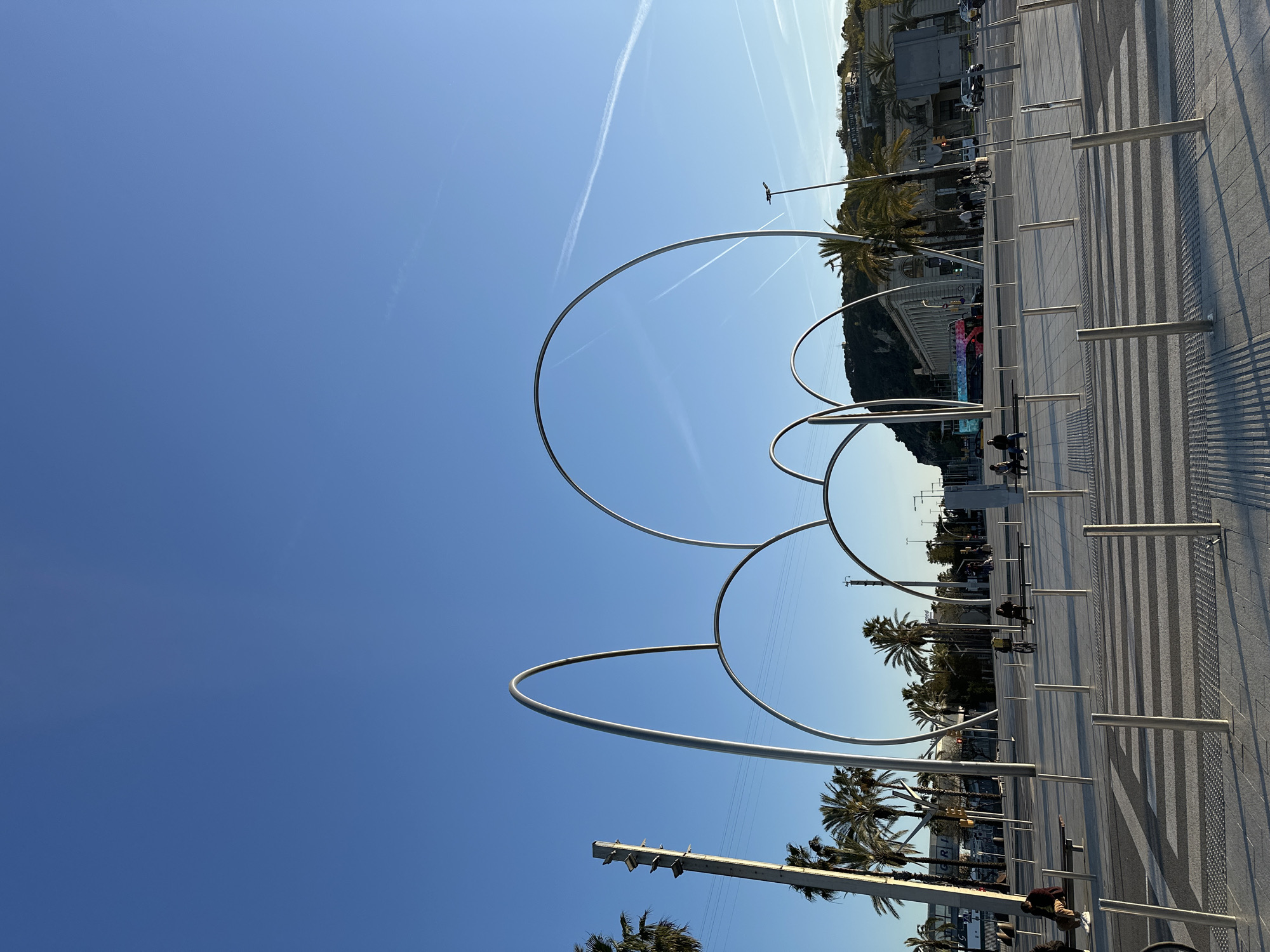Tourist captures Barcelona Port Vell landmarks during afternoon stroll