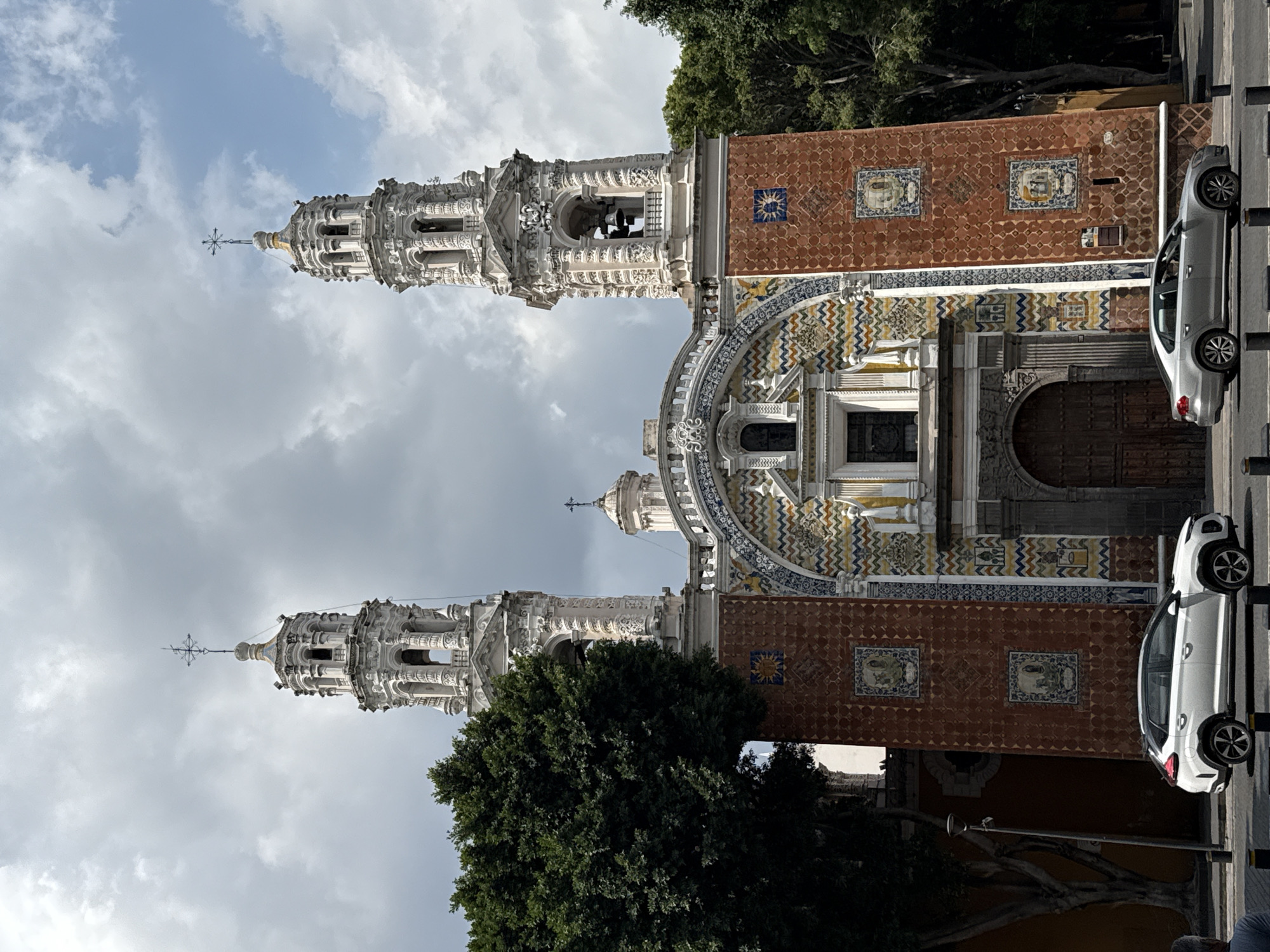 Tourist documents historic Puebla church and monuments during evening visit