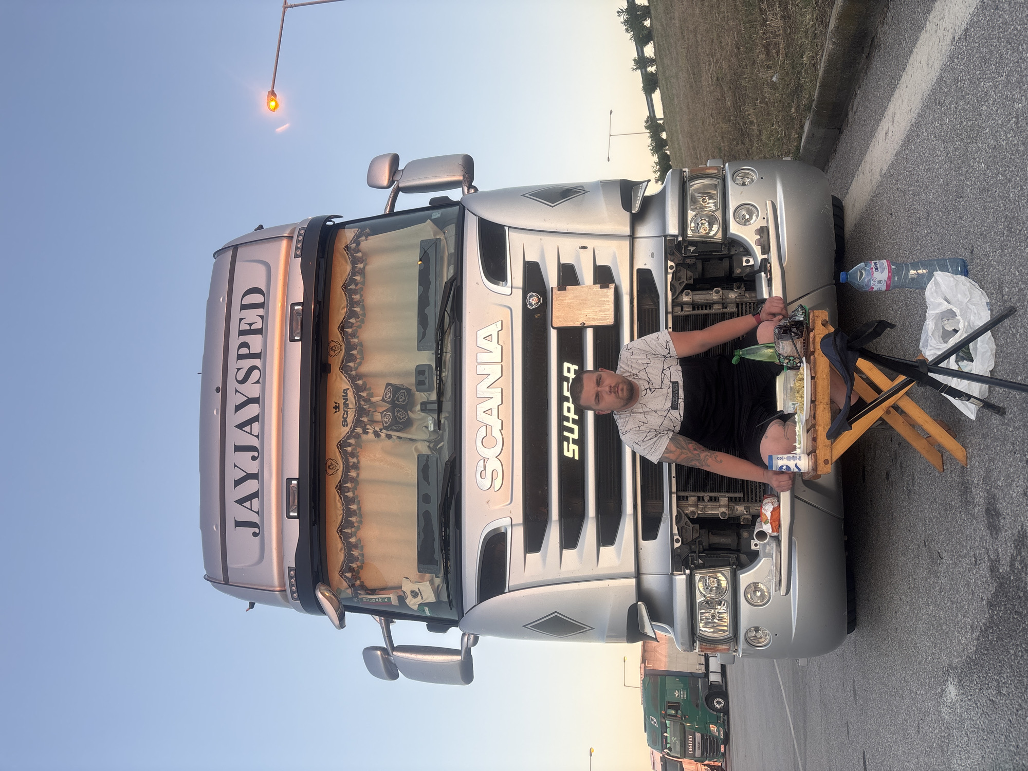 Evening trucking stop with commercial vehicles and meal break