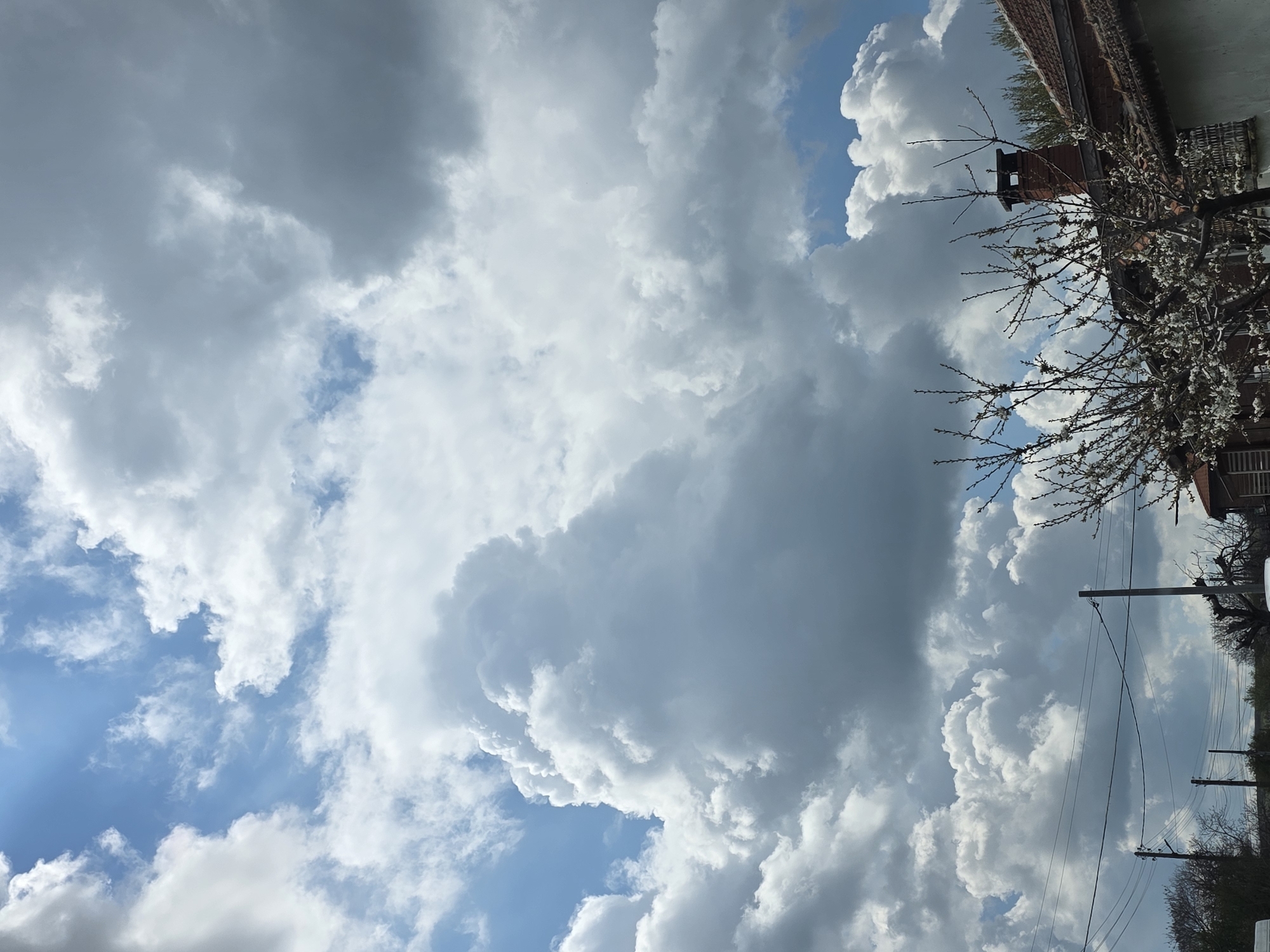 Mixed cumulonimbus clouds observed with blue sky patches visible