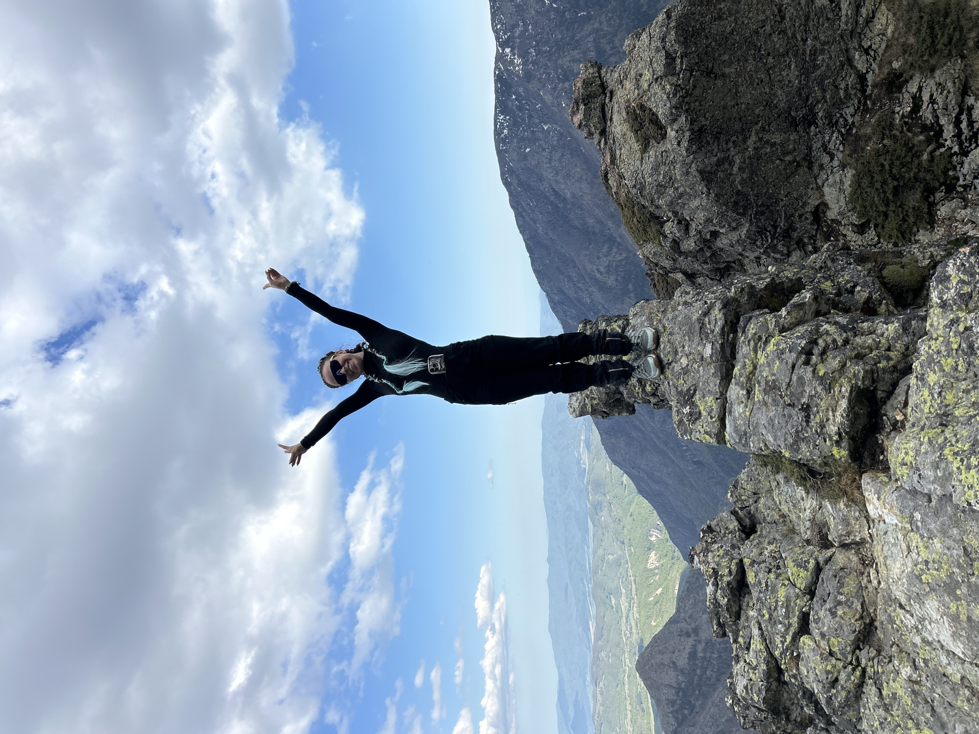 Person poses on mountain ledge in Kalofer, Bulgaria