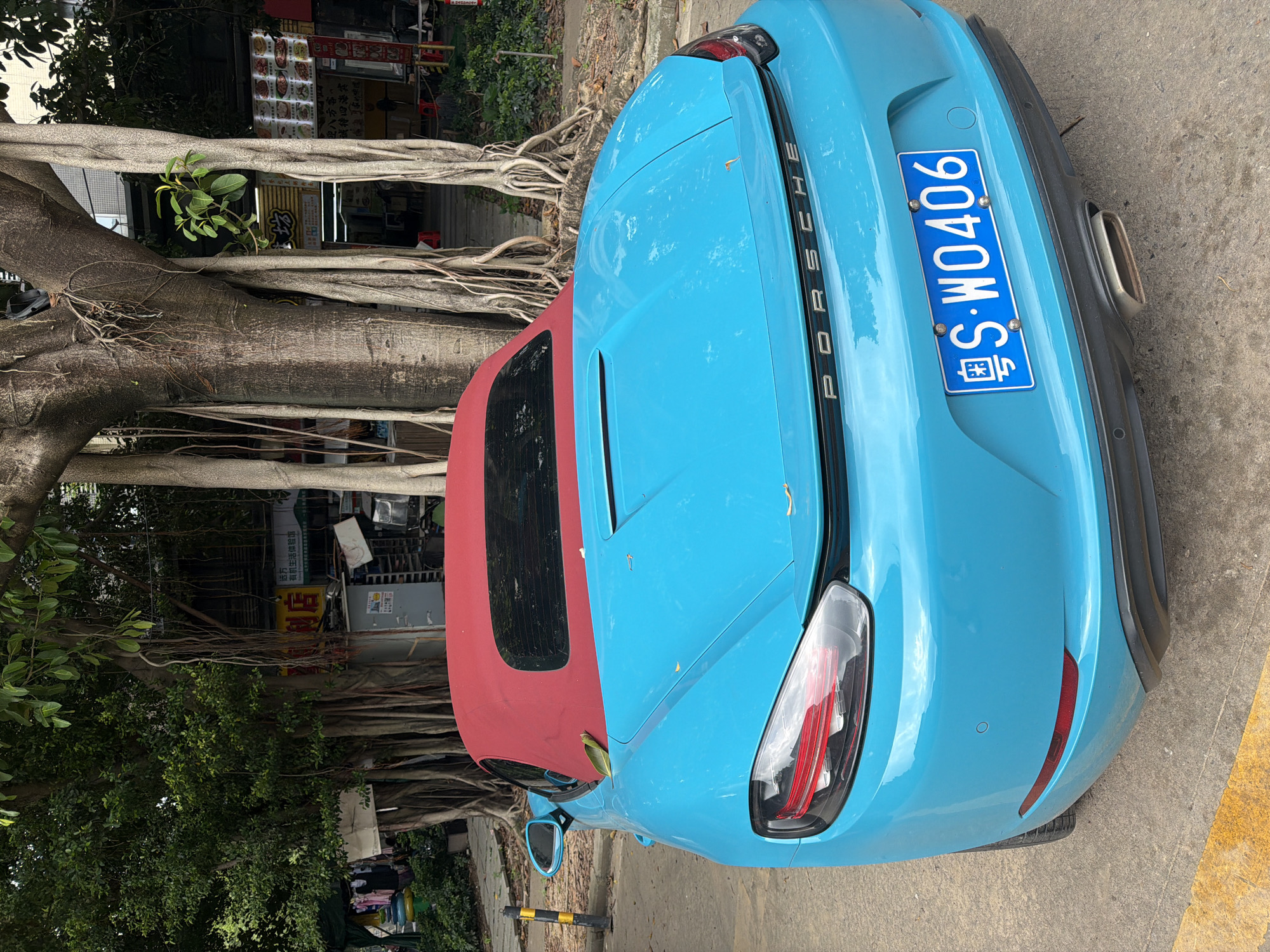 Blue Porsche convertible parked in Panyu District, China