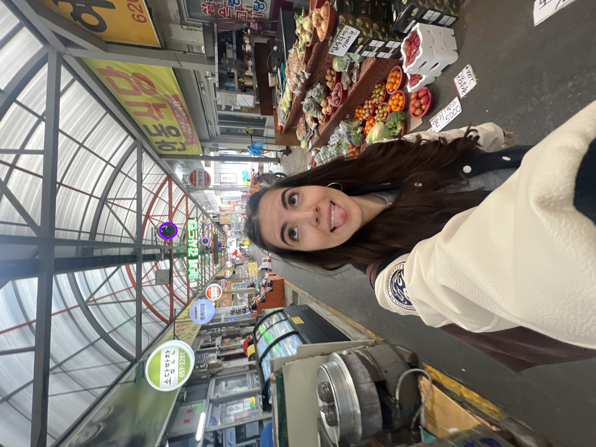 Woman takes selfie in traditional Daegu market