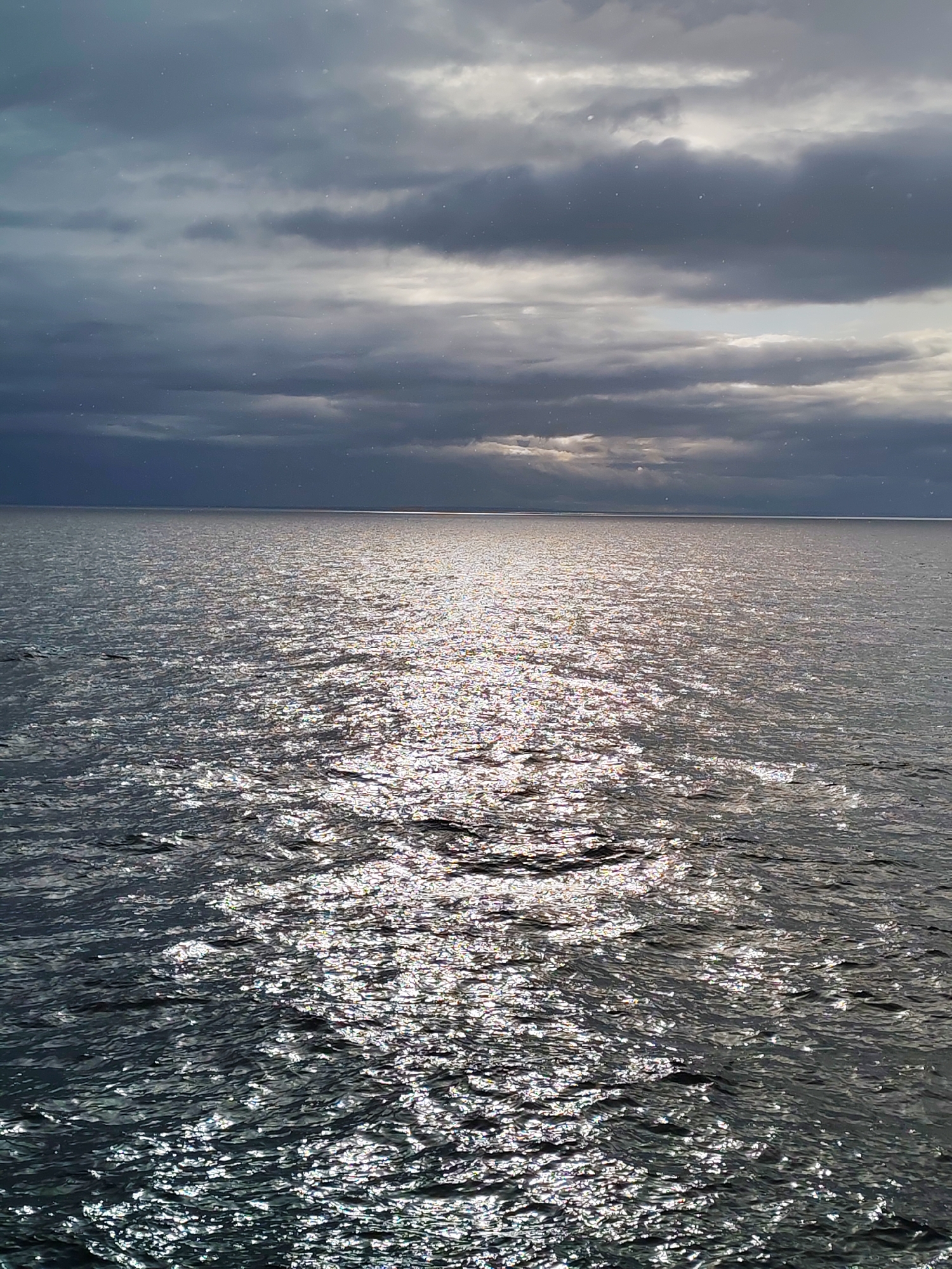 Overcast skies with sunlight breaks observed over Russian waters