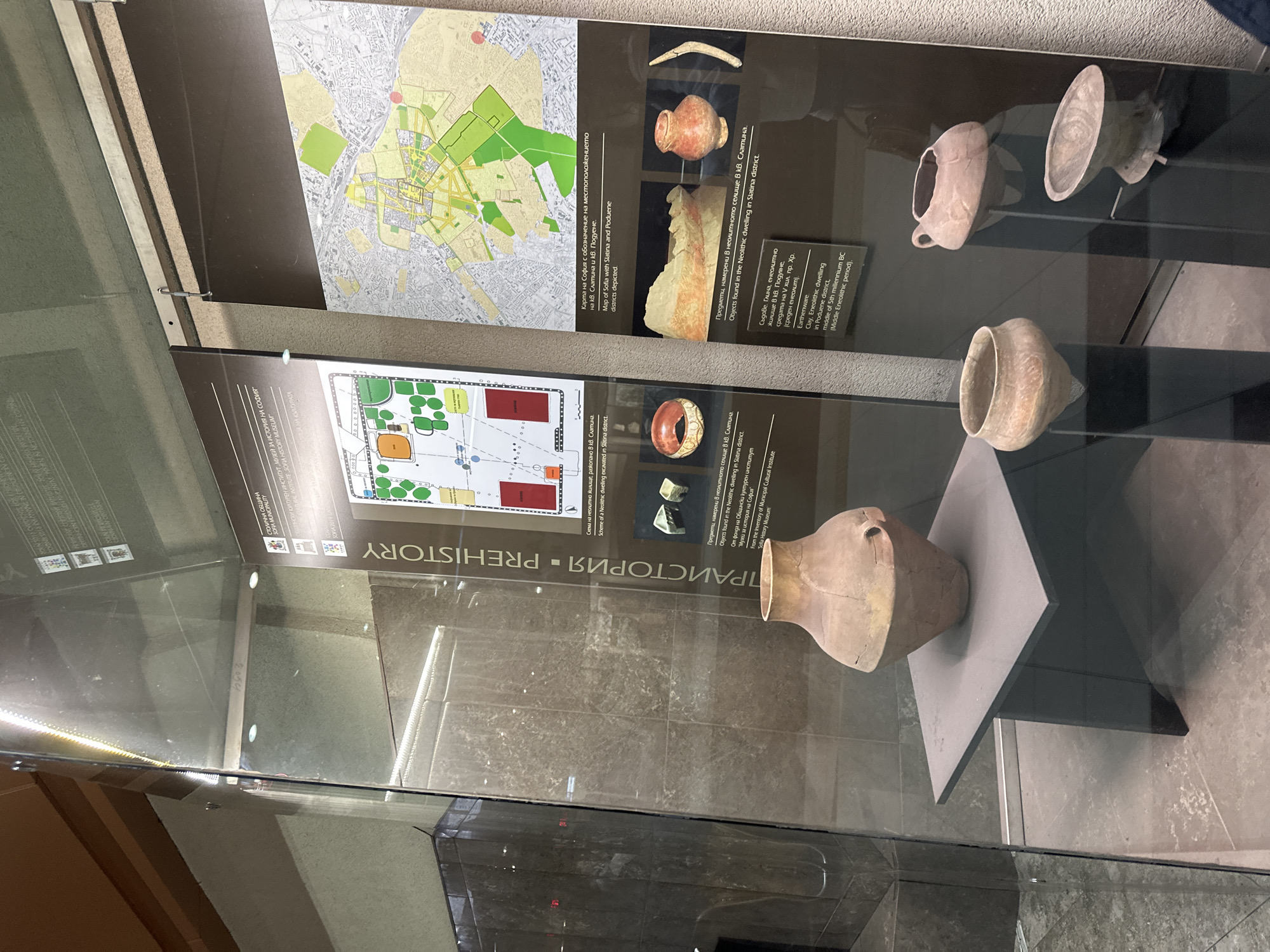 Museum visitor documents Sofia history exhibits, spots sleeping cat