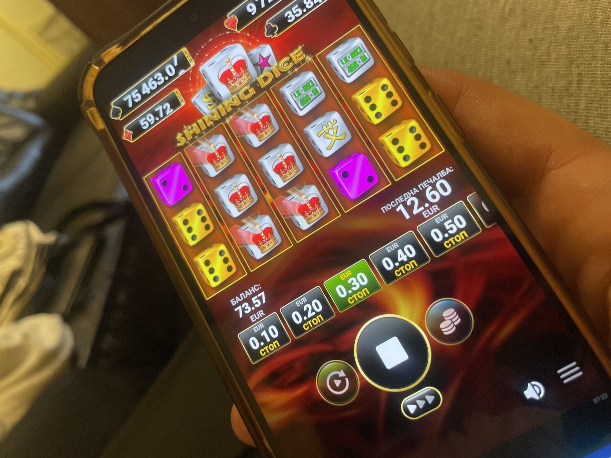 Person plays online dice gambling game on phone in Bulgaria
